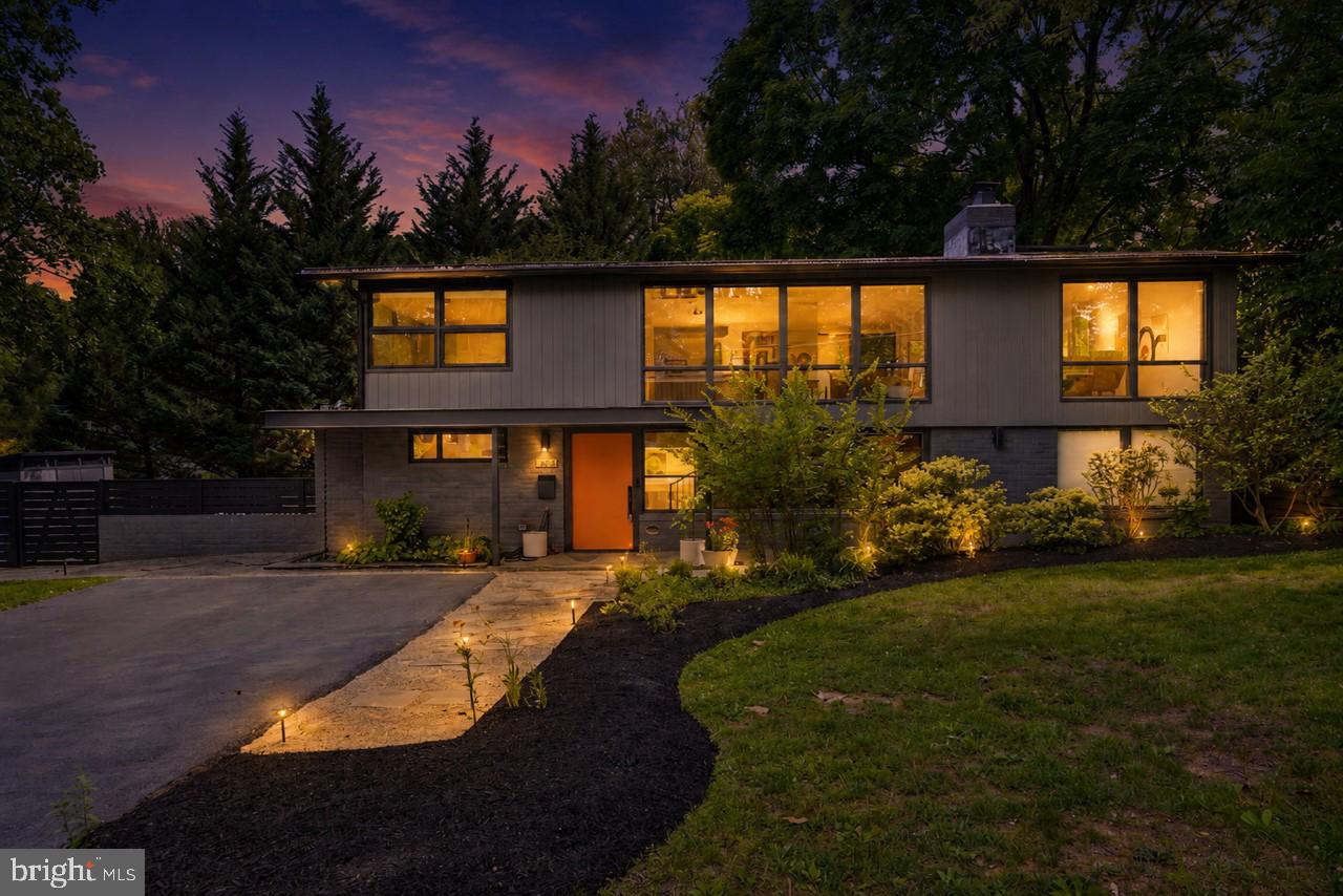 Some houses you tour. This is one you fall for. A true Holmes Run Acres mid-century modern, it sits in one of Virginia's first planned communities and a designated historic district, with the register plaque on the house to prove it. Inside, Douglas fir ceilings soar above while walls of glass pull light and woodland views into every corner. The living and dining spaces feel open, bright, and connected, anchored by a white-painted brick fireplace and the warm original wood closet that defines the homes in this neighborhood. A skylit flex room makes an effortless office, studio, or creative retreat. A floating open-tread staircase leads to a second living space below — a den, media room, or playroom, however you live.
Held for more than a decade by only its second owners, the home has been thoughtfully stewarded: its character preserved, its comforts quietly updated. The primary suite is a retreat, a spa-like bath finished in marble and brass, a custom closet  and a private pea-gravel patio inspired by the owners' travels through the Mediterranean.  Behind the scenes, the essentials are handled: newer windows, updated systems, refreshed baths, and heated floors in the primary, all part of a 2020 renovation by Wiedemann Architects and GN Contracting.

Off the dining room, a two-level deck rests beneath a grand old tree, a private perch that feels worlds away. The gardens are their own quiet love story: beds of evergreens and perennials embrace the house. A fig tree and a persimmon tree come into season each year, and a raised bed sits ready for the next owner's tomatoes and herbs.

The part you can't renovate is the neighborhood. Holmes Run Acres gathers around Luria Park at its center, where neighbors know one another and community still means something.  Walk to the elementary school and community pool, and reach the restaurants, movies, and weekend energy of the Mosaic District in minutes. This community was designed to bring the outside in and people together. It still does.

Homes like this don't come along often. Neighborhoods like this, even less so. This one is ready for its next chapter!