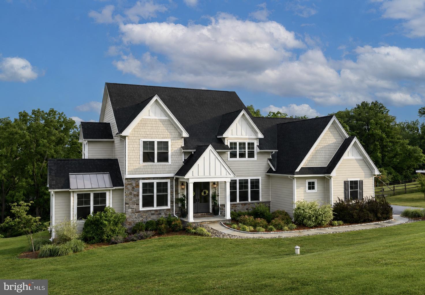 Welcome to 18 Popjoy Lane, an exceptional 4-bedroom, 4.5-bath residence nestled in the highly sought-after Marsh Lea community and award-winning Downingtown East School District. A rare opportunity to enjoy a premium lot with picturesque views of Marsh Creek Lake, the convenience of direct access to the lake and the Marsh Creek Trail system, and all the luxuries of new construction with lux finishes, thoughtful design, and outstanding indoor-outdoor living. A grand entrance begins with impressive 8-foot double front doors, opening to a stunning interior featuring premium hardwood flooring throughout the main level, upgraded 8-foot doorways, and custom millwork throughout. The foyer is flanked by an elegant formal dining room and a spacious living room or 2nd private office, creating the perfect setting for both everyday living and entertaining. At the heart of the home, the sun-filled family room is anchored by a gas fireplace and seamlessly connects to the beautifully appointed gourmet kitchen. The kitchen boasts upgraded stainless steel appliances, including a chef’s 6 burner Thermadore gas stove, Bosch dishwasher, built in microwave, and double ovens, premium honed Carrara marble countertops, abundant cabinetry, and a butler's pantry complete with additional refrigeration and matching Carrara marble surfaces.

Just off the kitchen, enjoy effortless indoor-outdoor living with access to the screened-in porch and expansive deck, ideal for taking in your picturesque Marsh Creek Lake views. A well-designed mudroom offers additional storage and a covered side entrance, while a powder room completes the main level.
Upstairs, the spacious primary suite serves as a private retreat, featuring a beautiful custom picture window, a generous walk-in closet, and a luxurious en-suite bath with dual Carrara marble vanities, a soaking tub, and a walk-in shower. A princess suite with a private bath, along with two additional generously sized bedrooms connected by a Jack-and-Jill bathroom, provide ample space for family and guests. Tucked away off the staircase landing, an additional private office with vaulted ceiling offers the perfect work-from-home setup. The finished walk-out basement provides endless possibilities for recreation, fitness, or entertaining and includes a full bathroom. Step outside to the lower patio and unwind in the hot tub while enjoying the privacy and scenic surroundings of the backyard. Additional highlights include premium landscaping and hardscaping, oversized 8-foot garage doors, and a highly desirable lot offering both privacy and breathtaking lake views, plus direct lake access as well as convenient neighborhood access to the Marsh Creek Trail system. Conveniently located near Marsh Creek State Park, Eagleview Town Center, shopping, dining, and major commuter routes, this remarkable property offers the perfect combination of luxury, comfort, and location. Don't miss the opportunity to make 18 Popjoy Lane your next home. Schedule your private showing today.
