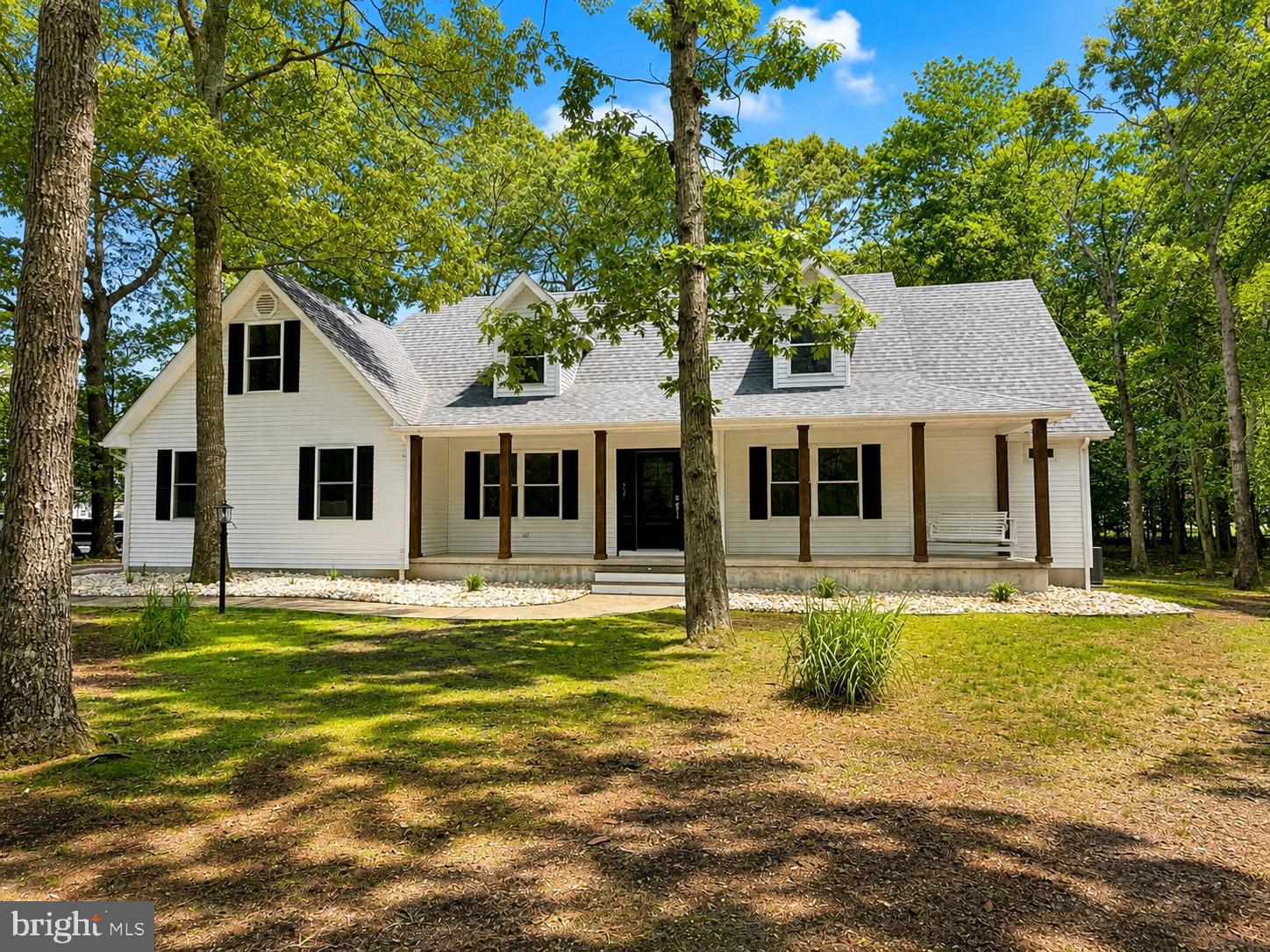Completely renovated Cape Cod-style home positioned on an oversized corner lot in the serene community of The Greens at Indian River, just a few miles from Bethany Beach and right around the corner from scenic walking trails at Holts Landing State Park. This beautifully updated home offers 3 bedrooms plus a den and an expansive bonus room, providing flexibility for a potential 4th bedroom, home office, gym, or recreation space. Renovated inside and out with high-end finishes throughout, features include luxury vinyl plank flooring, a redesigned open-concept kitchen with quartz countertops, subway tile backsplash, brand-new stainless steel appliances, and a spacious living area with a gas fireplace and two sets of sliding glass doors leading to a large deck and two screened porches overlooking the fully fenced backyard. The main level also includes a dining area, den/office, convenient half bath, laundry/mudroom with access to the 2-car garage, and a stunning primary suite featuring French doors to a screened porch and a spa-like bath with dual sinks and a large tiled walk-in shower. Upstairs you’ll find two spacious guest bedrooms, a renovated full bath, and an oversized bonus room with endless possibilities. Additional highlights include an outdoor shower for easy cleanup after a day at the beach. Ideally located near Cripple Creek Golf and Country Club and adjacent to Holts Landing State Park, residents can enjoy some of the area’s best coastal outdoor recreation just moments from home. The park offers bayfront walking and nature trails, fishing and crabbing piers, public boat and kayak launches, picnic areas, and seasonal family-friendly events including summer concerts and bayside programs. This exceptional property offers the perfect blend of coastal living, modern luxury, and access to the natural beauty of Delaware’s inland bays.