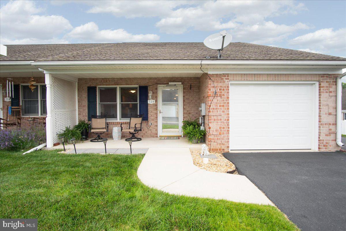 Welcome to easy, one-level living in the desirable East Ridge community! This beautifully maintained all-brick end-unit townhome offers the perfect combination of comfort, convenience, and outdoor space in a highly sought-after Hagerstown location. Just minutes from shopping, dining, medical facilities, regional parks, golf courses, major commuter routes, and Interstate access, you'll enjoy the convenience of having everything you need close to home. Inside, the open floor plan creates a warm and welcoming atmosphere with durable luxury vinyl plank flooring flowing throughout both the spacious living room and oversized kitchen. The living room features a ceiling fan and opens seamlessly into the heart of the home. Designed with both functionality and gathering in mind, the kitchen offers an abundance of cabinetry and countertop space, recessed lighting, all appliances, and an impressive breakfast bar with additional storage and plenty of seating, making it the perfect space for meal preparation, casual dining, or visiting with family and friends. The home features two generously sized bedrooms and two full bathrooms, including a spacious primary suite with a double vanity and a low-threshold walk-in shower equipped with grab bars for added accessibility. Just off the attached one-car garage, you'll find the convenient laundry area complete with a utility sink and adjoining utility/storage room. Outside is where this property truly stands apart. Enjoy your morning coffee from the covered front porch with its level entry and automatic door opener, offering added accessibility and convenience. The large, fully fenced backyard provides an exceptional amount of outdoor space rarely found with townhome living. Whether you enjoy gardening, relaxing on the patio, entertaining guests, or simply having room to spread out, you'll appreciate the spacious yard, large patio, storage shed, and additional green space that wraps around the side of the home. Additional highlights include all-brick construction, an attached one-car garage, an oversized paved driveway with additional parking beside the garage, and updated HVAC and water heater (2022). Combining low-maintenance living with an exceptional outdoor setting and a convenient central location, this is a wonderful opportunity to enjoy comfortable living in one of Hagerstown's most desirable communities.