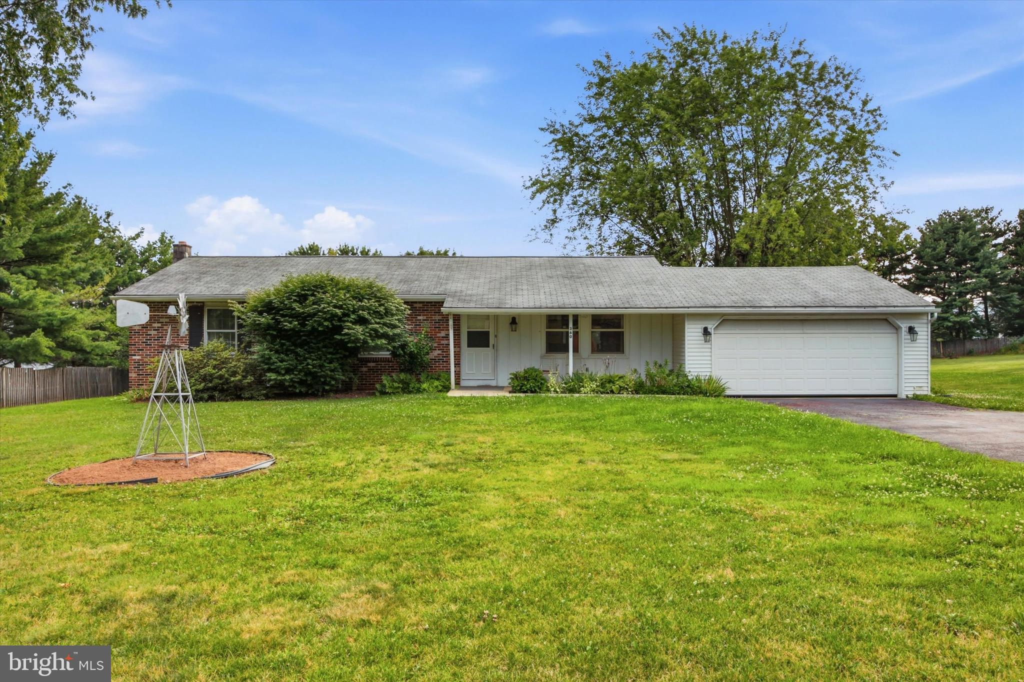 Offered for the very first time since 1979, this cherished rancher sits on a sprawling 1 acre lot in desirable Harleysville. Deeply treasured for over four decades, this home is ready for its next owner to bring their vision, sweat equity, or investment plans to life. Start by welcoming guests from the charming front porch and step right inside where you'll find a functional single level floor plan featuring 3 bedrooms and 2 full baths to the left of the entrance and family living to the right of the home. The heart of the home features a warm, inviting kitchen that is naturally friendly for cooking and gathering with family, complete with a newer dishwasher.  Adjacent to the kitchen is a large eating area that flows effortlessly right into the expansive family room addition, creating a fantastic, connected layout for everyday living and entertaining.  The light-filled family room addition boasts three full walls of windows with views and direct access to the expansive backyard. The large family room addition is complete with a crawl space foundation beneath.  While the home retains some of its original character and is ready for your personal updates, peace of mind comes easy with a BRAND NEW HVAC unit that has both central air and backup heat and features a transferable warranty to the new owner. The partially finished basement adds incredible versatility, offering a half bath, space for an office or additional bedroom, and a handy kitchenette. All of this is ideal for extended living or extra storage. A convenient, attached garage completes the package. 360 Oak Drive offers enjoyment of the best of both worlds; privacy and room to roam on a full acre of land, paired with quick, seamless proximity to major commuter routes, shopping, and local amenities. This home is a rare find with solid bones, authentic heart, and endless potential. Bring your updates and make this loved home your own!