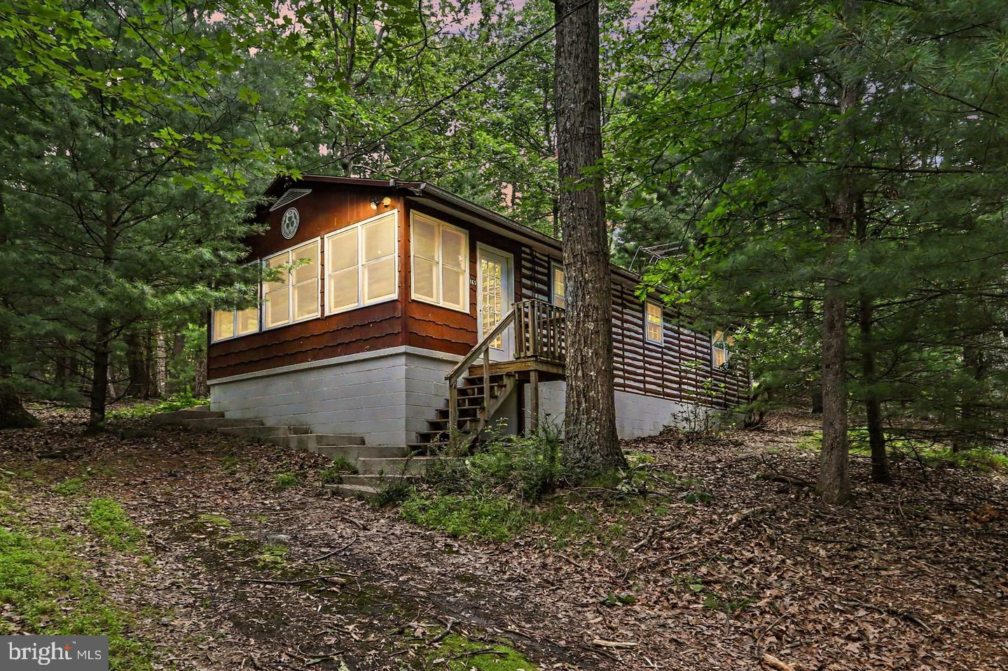 Located in the Gettysburg School District, this charming one-level property offers ONE ACRE directly adjacent to Michaux State Forest. Enjoy stepping right from your backyard into the beauty of Michaux State Forest and all the memories waiting to be made. The inviting open layout connects the kitchen and living room, creating a comfortable space for everyday living or a peaceful getaway. The kitchen features new flooring, and the bedrooms offer hardwood floors. This property includes two bedrooms, an updated full bath with custom barn door and new flooring, convenient main-level laundry, a sunroom/office/flex space with wood ceiling and new tile flooring, and a cozy stone fireplace adding warmth and character. Step outside to enjoy the patio and fire pit area, a wonderful place to relax, gather with friends, and take in the natural surroundings. ***Buyers interested in exploring potential short-term rental opportunities are encouraged to contact Franklin Township directly for guidance regarding permitted uses and requirements. Township contact information is provided in the MLS documents.***Whether you are looking for a full-time residence or a peaceful escape, this property offers the opportunity to enjoy the tranquility of nature while remaining close to Gettysburg and Chambersburg amenities. Conveniently located for commuters to US Route 15 and I-81. Schedule your showing appt today!