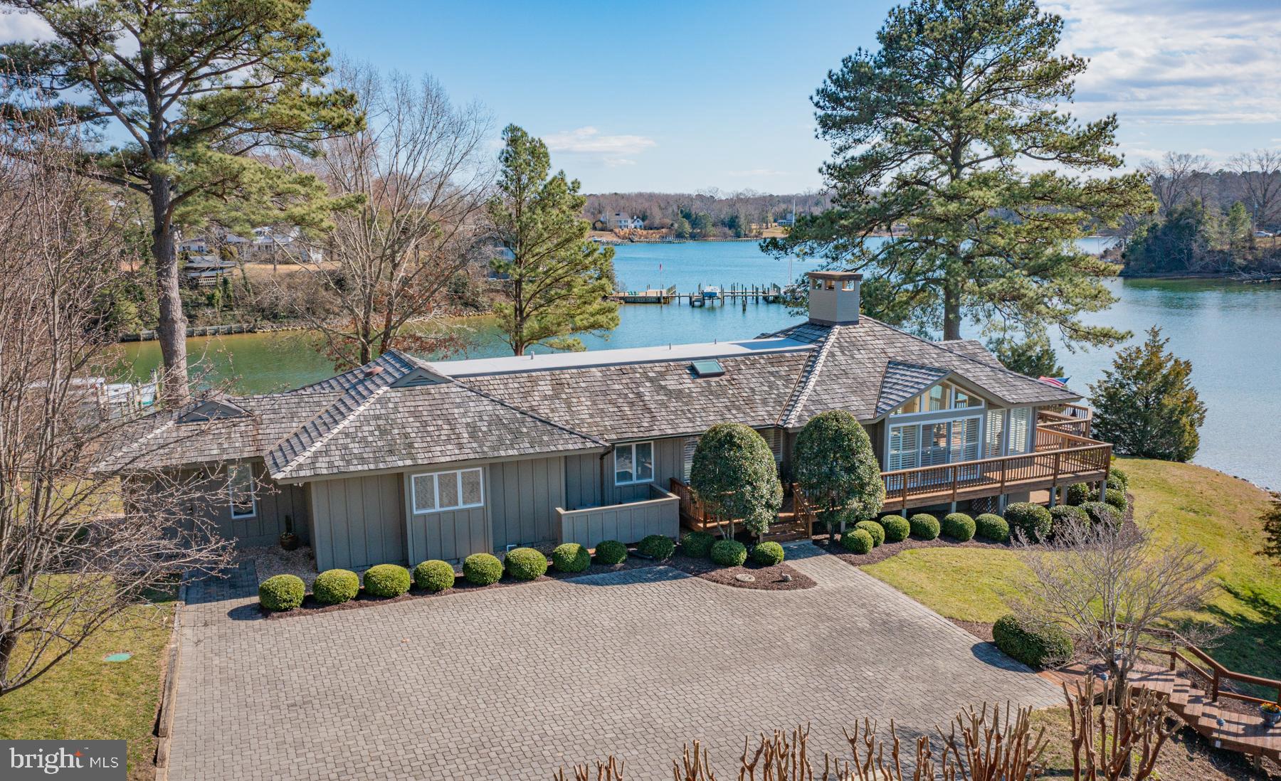 Architectural gem in the heart of golf cart friendly Irvington, this custom home showcases both coastal flair and comfortable sophistication.  Perched on a stunning one acre point of land, the special home offers the best of Irvington living and features huge water views of Carter’s Creek.  In addition to a new dock to 7’+ MLW, the wrap around deck and waterside pool make for ideal outdoor living.  The home’s main level offers a large and open living/dining space with vaulted ceiling, a welcoming foyer with skylight and a kitchen with island and views of the pool and creek.  The first floor also boasts a waterside owner’s suite with remodeled bath, multiple closets and private office, an ensuite guest bedroom, a powder room and laundry. Two ensuite lower level bedrooms both include water views and access to a waterside patio.  A lower level unfinished space with exterior stairs to the pool area is ideal for storage.  This one of a kind property is landscaped to perfection and has been lovingly maintained by the two families who have owned it.