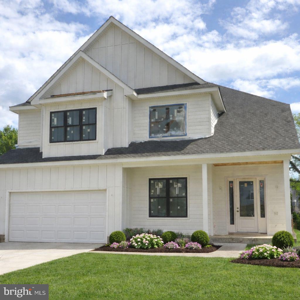 Experience luxury living at its finest at 5012 6th St N, a spectacular new construction home in Arlington’s sought after Brandon Village neighborhood. This residence offers a bright, elevated feel throughout with expansive black-frame windows and thoughtfully curated high-end finishes. The main level welcomes you with a dramatic two-story foyer, soaring ceilings, and walls of windows that flood the home with natural light. Elegant details include engineered white oak flooring in a striking hexagon pattern, crown molding, and refined finishes throughout. Designed for both everyday comfort and entertaining, the open layout features a showstopping gourmet kitchen with an oversized island with seating, premium stainless steel appliances, an expansive walk-in pantry, and a sunny breakfast nook with access to the rear deck. The adjacent family room offers a cozy gas fireplace, while the separate formal dining room with coffered ceilings is perfect for hosting. A versatile main-level office/bedroom includes a closet and ensuite full bath. You’ll also love the thoughtfully designed mudroom with built-ins, sink, and full-size laundry, offering dual access from the interior and the oversized two-car garage. Upstairs, retreat to an impressive primary suite with cathedral ceiling, sitting area, mini bar, and two walk-in closets. The spa-inspired bath features double vanities, dual showers, and a soaking tub for the ultimate unwind. The secondary bedrooms are beautifully planned: two share a Jack-and-Jill bath, while another enjoys a private full bath. A second upper-level laundry room with cabinetry and counter space adds everyday ease. The walk-out lower level is an entertainer’s dream with a spacious recreation room, large wet bar, dedicated fitness area, and a sixth bedroom with full bath, ideal for guests. Step outside to a fenced backyard with pavers, perfect for relaxing or hosting.