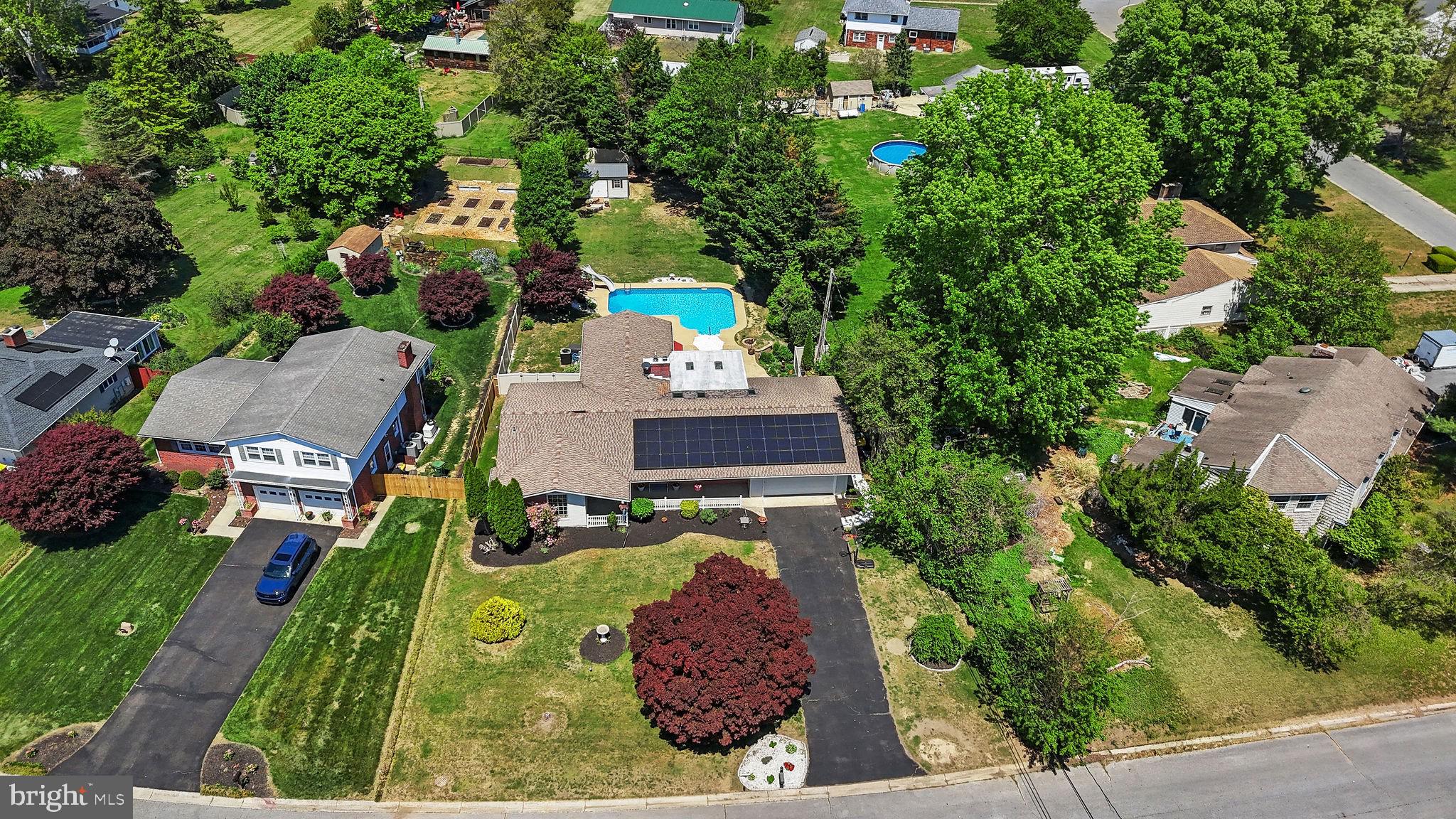 Prepare to SPLASH into Summer!  If you've been waiting for a home that truly has everything, this is it.  Situated in a highly sought-after community with no HOA, this beautifully updated and well-maintained home offers convenient one-level living with a full basement, on a spacious private lot featuring a fully fenced backyard, in-ground heated pool, and two rear decks.   The recently installed solar panels, which are owned - not leased- significantly reduce electric costs with some months resulting in no electric bill.  Upon entry, the home opens to light-filled living areas with beautiful hardwood flooring that flows through the living room, formal dining room, and kitchen, which features stunning granite countertops and stainless steel appliances.  The spacious family room offers a warm and inviting atmosphere, highlighted by a full brick fireplace with a high-efficiency insert, perfect for cozy evenings. Enjoy the large enclosed sunroom with a bar area, wine refrigerator, and half bath, offering an ideal space for entertaining or everyday enjoyment.  The primary suite serves as a relaxing retreat, complete with a spacious ensuite bath featuring a large walk-in shower, jetted tub, and two walk-in closets. Sliding doors provide direct access to a private rear deck and pool, ideal for enjoying morning coffee or unwinding at the end of the day.  Three additional bedrooms - including one bedroom with it's own ensuite bath, and a third full bathroom provide flexibility for multigenerational living or a second primary suite. A spacious laundry room with storage and a freezer is conveniently located just off the kitchen. The partially finished full basement provides endless possibilities, whether you envision a theater room, home gym, office, or recreation space, while still offering plenty of storage. The large attached two car garage and new 10 x 20 shed gives you plenty of room for vehicles and lawn/garden equipment.  Seller recently added a new concrete walkway leading from the driveway to the backyard, a new hot water heater, dishwasher, garbage disposal, windows, flooring, and more.   Enjoy peaceful & private living, in an unbeatable location. Don’t miss your chance to make it yours!
