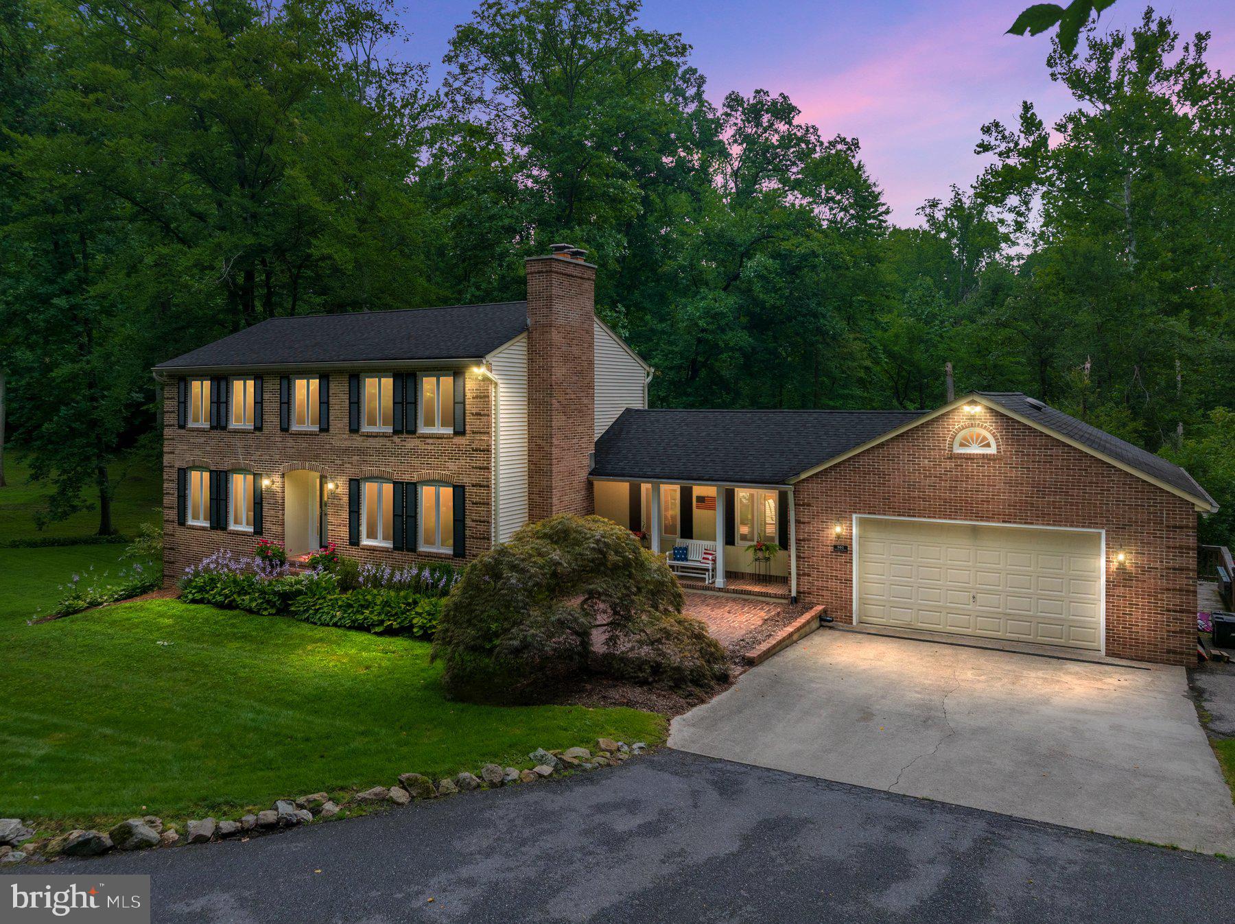 COMING SOON! Nestled on a breathtaking 2-acre homesite in the heart of Davidsonville, this beautifully landscaped brick-front home offers the perfect blend of privacy, space, and timeless appeal. Tucked away along a quiet, winding lane shared by only a handful of homes, the approach feels more like a scenic country drive than a neighborhood. Surrounded by mature trees, flowering perennials, an expansive lawn, and a charming gazebo, the park-like setting is truly exceptional. An expansive rear deck stretches across the back of the home, creating an incredible outdoor living space for entertaining, dining al fresco, or simply relaxing while taking in the peaceful views. Inside, you’ll find over 2,900 square feet of thoughtfully designed living space featuring a welcoming foyer, spacious formal living and dining rooms, a cozy family room with a wood-burning fireplace, and an oversized recreation room filled with natural light and offering direct access to the deck. The kitchen features granite countertops, stainless steel appliances, a sunny breakfast area, and sliding glass doors overlooking the backyard. Upstairs offers four generously sized bedrooms, including a spacious primary suite complete with its own wood-burning fireplace, walk-in closet, dressing area, and private bath. Luxury vinyl plank flooring extends throughout the upper level. An oversized expansive garage provides exceptional room for multiple vehicles, storage, hobbies, or workshop space, while the walk-out lower level offers over 1,000 square feet of additional space ready to fit your needs. Lovingly maintained and set in one of Davidsonville’s most desirable locations, this special property offers the rare opportunity to enjoy the beauty of country living while remaining just minutes from shopping, dining, commuter routes, and top-rated schools. Coming to the market July 10th!