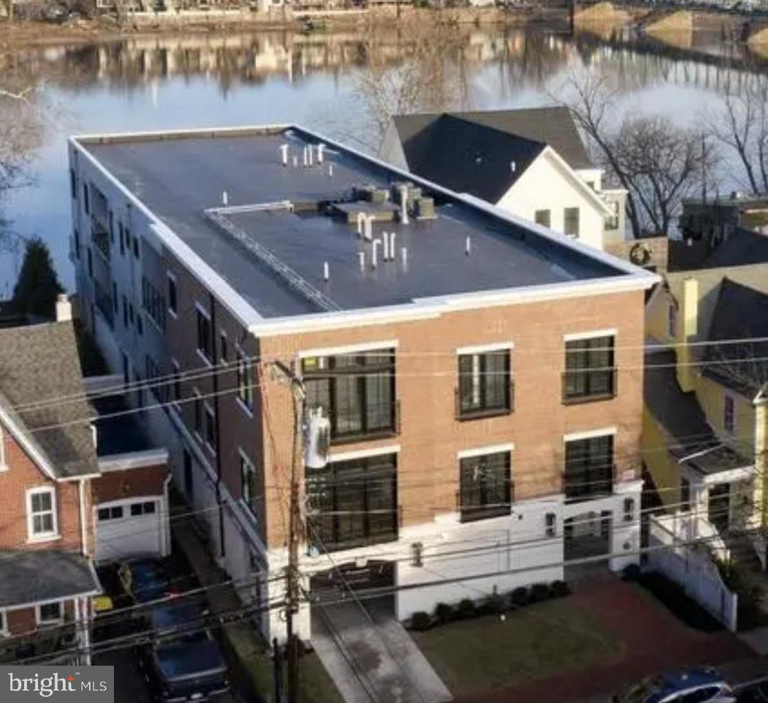 RiversEdge offers 4 sophisticated, luxury Residences providing carefree living at its finest in the heart of New Hope. Condo C is the top floor, street front residence with river views from the northern side balcony and views of the New Hope Lambertville bridge. This 3 Bedroom 2 1/2 bath  condo is  beautifully appointed with over 2500 sq ft of living space and all the amenities one could wish to have in a luxury home. Enter the stunning residence with nearly 10 ft ceilings and hardwood floors thorough out. The Gourmet kitchen features custom white cabinetry, quartz counters, high end stainless steel appliance package, built in microwave and wine refrigerator. Attached is the Formal dining area with river views and a side balcony perfect for morning coffee or evening relaxing. The large Family room has a cozy gas Fireplace. The luxurious Master Suite has an opulent Master bath with glass shower and soaking tub. There are two additional bedrooms sharing a full bath and an office. The Gorgeous expansive riverfront patio has breathtaking views and is perfect for relaxing or entertaining with the multi levels, firepit, and stairs for access to the river.  There is a dock with boat slip. The property has a secure gated parking garage with 2 designated spaces for each condo and  individual storage units. Located within walking distance to all the charm, history, shops, restaurants and nightlife New Hope has to offer!