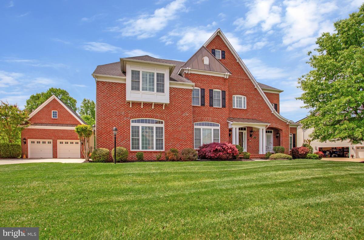 Welcome to Your Private Luxury Retreat in Westwood at Woodmore North.

Tucked away on nearly an acre of beautifully landscaped grounds in the prestigious Westwood community, this extraordinary Colonial estate offers the perfect blend of elegance, comfort, wellness, and recreation. With over-the-top living spaces, exceptional outdoor amenities, and a highly desirable floor plan, this is the kind of home buyers wait years to find. 

Opportunities like this in Westwood are rare. One visit may be all it takes to fall in love. From the moment you arrive, you'll be impressed by the stately curb appeal, expansive driveway, and rare five-car garage capacity. Step inside and discover a home thoughtfully designed for both grand entertaining and everyday living.  

A standout feature rarely found in today's market is the main-level bedroom suite complete with a private ensuite bath and walk-in closet—ideal for multi-generational living, long-term guests, a private wellness retreat, home office suite, or luxury guest accommodations.

The heart of the home is a stunning gourmet kitchen featuring upgraded countertops, a gas cooktop, oversized island, and abundant gathering space where family and friends naturally come together. Formal and casual dining areas provide flexibility for everything from holiday celebrations to intimate dinners, while the spacious family room creates the perfect setting for making memories. The breakfast area opens seamlessly to a charming enclosed porch, extending your living space and creating the perfect indoor-outdoor lifestyle.

Upstairs, the owner's retreat is nothing short of spectacular. Relax in your private solarium-style sitting room, enjoy dual walk-in closets, and unwind in the spa-inspired bath featuring a soaking tub with peaceful wooded views, a stunning stone walk-in shower, and a serene atmosphere designed for total relaxation.

Three additional upper-level bedrooms offer exceptional comfort and functionality, including a private ensuite bedroom and a thoughtfully designed Jack-and-Jill layout with individual vanity spaces, providing privacy and convenience for family members and guests alike.

The fully finished walkout lower level is an entertainer's dream. Enjoy movie nights in your dedicated home theater, create your personal fitness studio, host game nights, or simply relax in the expansive recreation areas. An additional unfinished section offers incredible storage or the opportunity to customize even more living space to fit your vision.

Outside, the lifestyle truly shines. Situated on a private .92-acre homesite backing to mature trees, this backyard oasis offers the peace and privacy you've been searching for. Enjoy your morning coffee on the screened porch, entertain on the expansive deck, or challenge friends and family to a game on your very own basketball sport court. 

Property Highlights
✔ Prestigious Westwood at Woodmore North location
✔ Nearly 1-acre private wooded homesite (.92 acres)
✔ 5 Bedrooms | 5.5 Bathrooms
✔ Rare Main-Level Ensuite Bedroom Suite
✔ Luxurious Owner's Retreat with Sitting Room & Spa Bath
✔ Gourmet Kitchen with Large Gathering Island
✔ Home Theater & Finished Walkout Basement
✔ Screened Porch & Expansive Deck
✔ Private Basketball Sport Court
✔ 5-Car Garage Capacity (3 Attached + 2 Detached)
✔ Extensive Storage & Future Expansion Opportunities

This is more than a home—it's a lifestyle destination where luxury, recreation, wellness, and convenience come together in one remarkable property.

Price Improved to make home more accessible. Offer deadline in place. Seller reserves the right to accept an offer before the deadline. Confer with your agent or call with any questions.