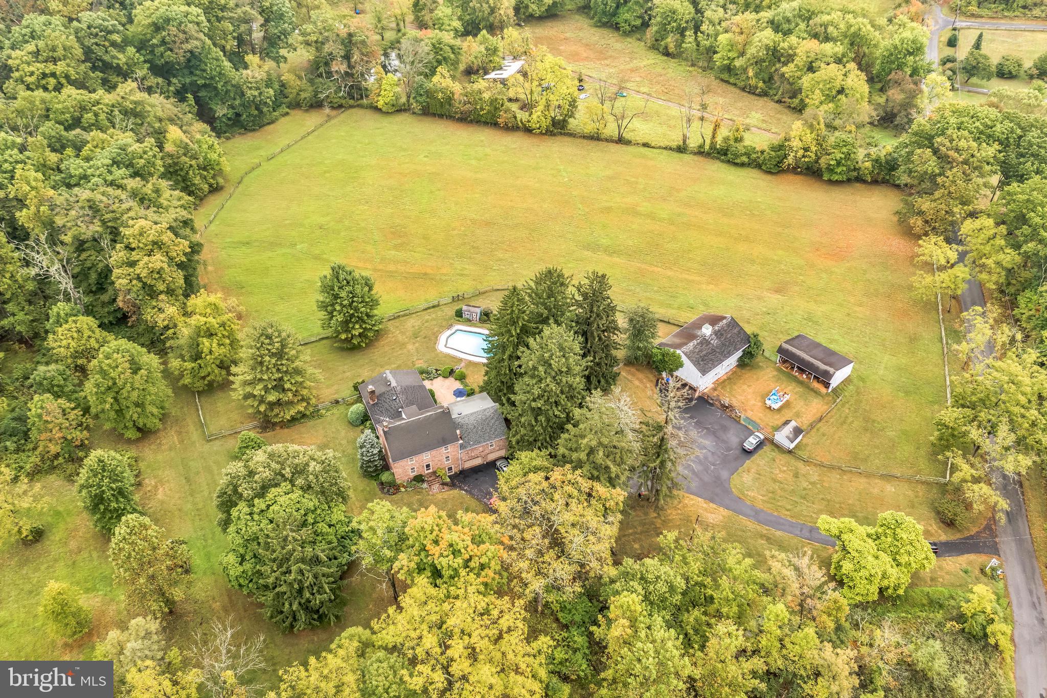 THREE SEPARATELY DEEDED PARCELS 

Discover the serene beauty of enchanting Pleasant Valley Farm, a historic property circa 1830 that perfectly blends classic charm with modern amenities. Nestled on 18 ACRES across three SEPARATELY deeded parcels (8, 5, and 5 acres), this stunning estate is a rare find in a peaceful rural neighborhood. Maximum privacy and tranquility for the discerning owner.

This beautifully preserved and lovingly cared for home offers three finished levels, featuring a unique concrete basement—an uncommon feature for farmhouses of its age .The home features versatile living spaces with views of the picturesque landscape.  The main level includes a spacious guest/nanny/in-law suite, ideal for visitors or extended family. Enjoy entertaining in the large dining room and cozy living room, complete with a walk-in fireplace. The updated kitchen flows into a fireside family room, while an oversized screened porch invites you to relax with peaceful views.  The second floor master suite boasts a sitting area/office, a walk-in closet, and a spacious bathroom. Two additional bedrooms share a convenient hall bath, bringing the total to four to five bedrooms. The third level offers a bonus space or 5th bedroom. The property features an in-ground pool and ample space for recreational activities. The expansive lot offers endless possibilities for gardening, play, or simply unwinding. With great sites available for a tennis or pickleball court, you'll enjoy outdoor fun right at home. There’s also potential for additional activities in the barn’s second floor.  Set back from the road, this property ensures maximum privacy and tranquility, making it an ideal retreat. Chestnut Hill Road is lightly traveled, enhancing the peaceful ambiance. 
The three parcels are aggregated solely for tax savings under Act 319, providing an attractive financial advantage. Don't miss this unique opportunity to own a piece of history in a stunning natural setting. Schedule a showing today and experience the charm of Pleasant Valley Farm! 17-06-0058.1100, 17-06-0058.1000, 17-06-0058.0900