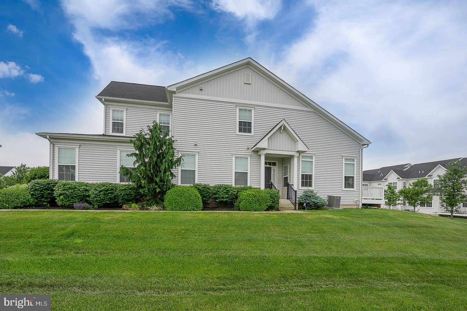 Welcome to 453 Barclays Way, a beautifully maintained end-unit carriage house in the Reserve at Providence Crossing, built in 2019 and thoughtfully designed for comfortable main-floor living. Ideal for downsizing without sacrificing space, this bright and airy home features a sought-after main-level primary suite, a private office/den with glass-paneled doors, and abundant oversized windows that fill the rooms with natural light.
The open-concept kitchen, dining, and living areas create an easy flow for both daily living and entertaining. The kitchen features granite countertops, a gas cooktop, a built-in wall oven and microwave, a pantry, and a large island for casual dining and gathering. From the dining room, sliding doors lead to a composite deck overlooking green space. The spacious primary suite offers a walk-in closet plus a luxurious ensuite bathroom with a walk-in shower, double vanity, and linen closet, while the nearby main-floor laundry adds everyday convenience. A powder room and oversized one-car garage complete this level.
Upstairs are two generously sized bedrooms, one with a walk-in closet, and a private entry to a shared full bath. The versatile loft overlooks the great room and has access to the hall bath. Additionally, there is a large linen closet and unfinished space that could potentially become a 4th bedroom. The expansive basement offers excellent storage or future finishing possibilities.
Additional highlights include an underground sprinkler system and an ADP security system. The community features scenic walking paths with Greenfield Outdoor Fitness stations, sidewalks and plentiful visitor parking. Located in the highly regarded Spring-Ford School District, this home offers low-maintenance living in a quiet suburban setting with convenient access to King of Prussia, shopping, dining, and major commuter routes.