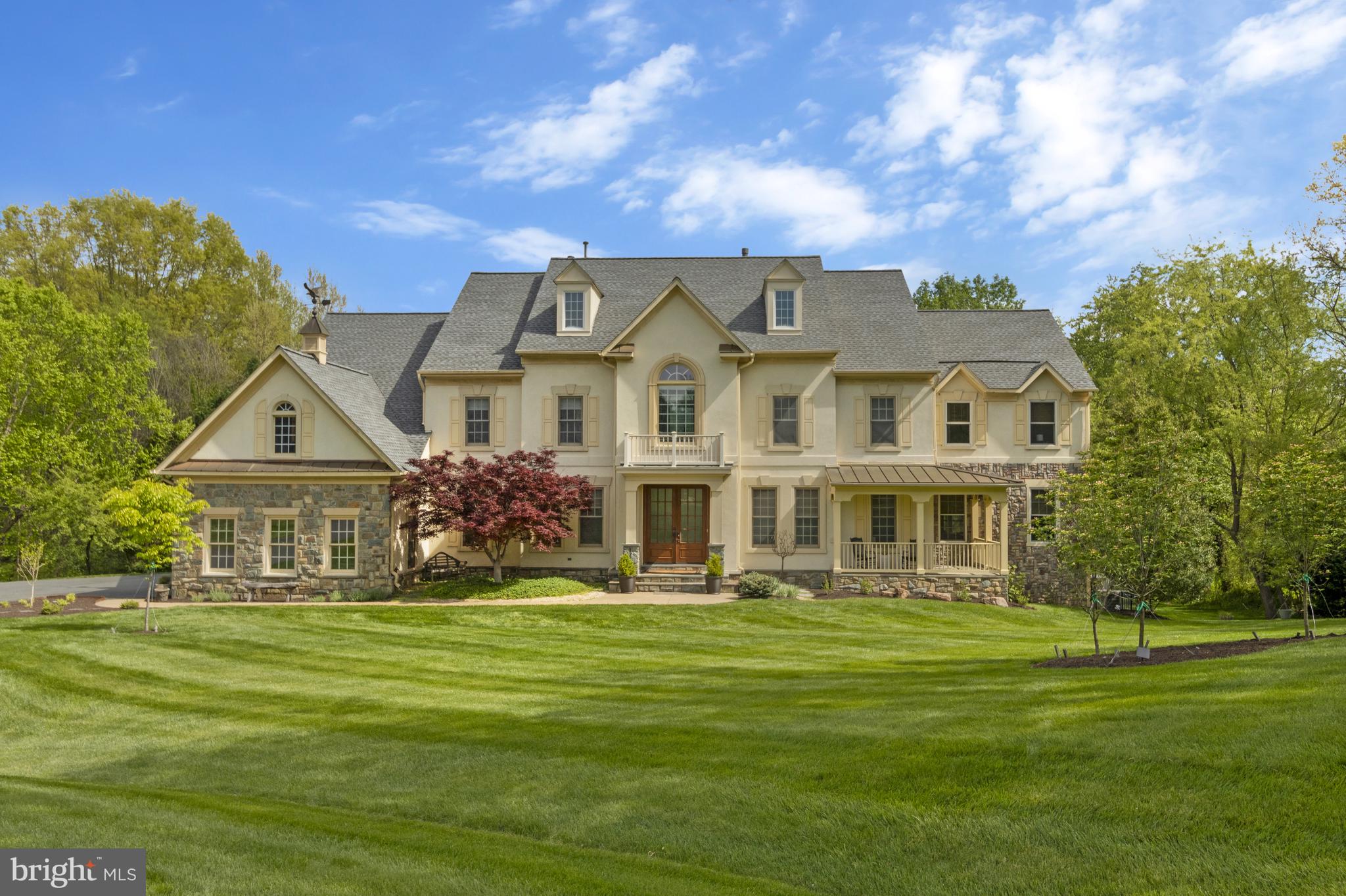 Open Sunday May 5th from 2-4pm. Introducing a magnificent French country estate nestled in the serene surroundings of Great Falls!  Situated on nearly 2 acres of private land, this remarkable property boasts meticulously landscaped grounds, offering a harmonious blend of wooded tranquility and picturesque vistas.  Outdoor amenities include an expansive patio complete with a fireplace, a sports court, maintenance free deck, and screened porch, all with access to the idyllic babbling brook that graces the property.  Step inside to discover an exquisite Provence-inspired interior adorned with the finest craftsmanship and finishes.  Gas fireplaces, chef’s kitchen equipped with top-of-the-line appliances, gleaming hardwood floors and custom-built features accentuate the elegant living spaces.  Thoughtfully designed for both formal entertaining and relaxed gatherings, the floor plan exudes sophistication while maintaining a welcoming ambiance.  With 8 bedrooms and 4 ½ bathrooms spread across 3 levels, including a lower level primed for entertainment with a spacious rec room, wet bar, gym, sauna and 2 private guest rooms, this home offers unparalleled luxury and comfort.  Ideally located within the highly sought-after Langley High School district and just minutes away from Tysons Corner, I-495 and the Reston Metro Station, this property presents a true lifestyle opportunity in the heart of Great Falls.