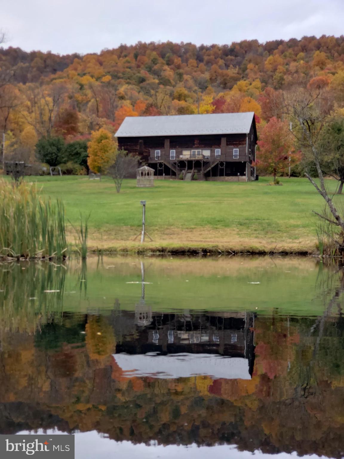 Bitter Goose Lodge – Turn-Key Investment Opportunity Near Lake Raystown, PA
Established hospitality business with over 20 years of loyal guest history, offering immediate income potential.

Nestled on 23 scenic acres in the heart of Raystown Country, the Bitter Goose Lodge provides both serene mountain retreats and exciting outdoor adventures. Surrounded by Pennsylvania's stunning Allegheny Mountains, this property features an expansive lodge, private cabins, and substantial event-hosting capacity, making it ideal for investors seeking a profitable and versatile business.

Property Highlights:
Main Lodge:
Spacious lodge sleeps up to 22 guests, offering a unique blend of rustic charm and modern comforts.

8 bedrooms (6 queen rooms, 1 twin room, bunk room)
Large country-style kitchen with modern amenities
Expansive living area with vaulted ceilings, electric fireplace, and wood-burning stove
Multiple decks with breathtaking mountain and valley views
Fully equipped kitchen and modern bathrooms
Four Private Cabins:
Each cabin comfortably sleeps 6 guests, perfect for families or smaller groups seeking privacy.

2 bedrooms (queen-size bed, twin bunk beds) plus queen pull-out couch
Fully stocked private kitchens
Air-conditioned, with cable TV
Private mountain-view decks
Amenities Included:

Sparkling in-ground swimming pool
Outdoor fire rings and picnic tables
Ample boat and trailer parking
Access to all 23 acres for hiking, wildlife viewing, and relaxation
Proven Revenue Stream:
With an established clientele and more than two decades of successful operations, Bitter Goose Lodge offers investors an immediate revenue stream. Its strong repeat-customer base provides stability and consistent annual income.

Event Venue Potential:
The lodge and grounds can comfortably accommodate events with up to 250 guests, offering significant income opportunities from weddings, reunions, to corporate retreats. The rustic charm and scenic backdrop make Bitter Goose Lodge a highly desirable event location.

Exceptional Location:
Minutes from Lake Raystown, renowned for boating, fishing, swimming, and water sports
Close proximity to Trough Creek State Park, featuring extensive hiking trails, picnic areas, and natural attractions
Easily accessible from State College (SCE) and Martinsburg (AOO) airports
Growth Opportunities:
Permits are in place for future expansion of additional cabins, allowing investors to further increase revenue and capitalize on high rental demand in this popular region.

Don’t miss this opportunity to own a thriving hospitality business with substantial growth potential.
