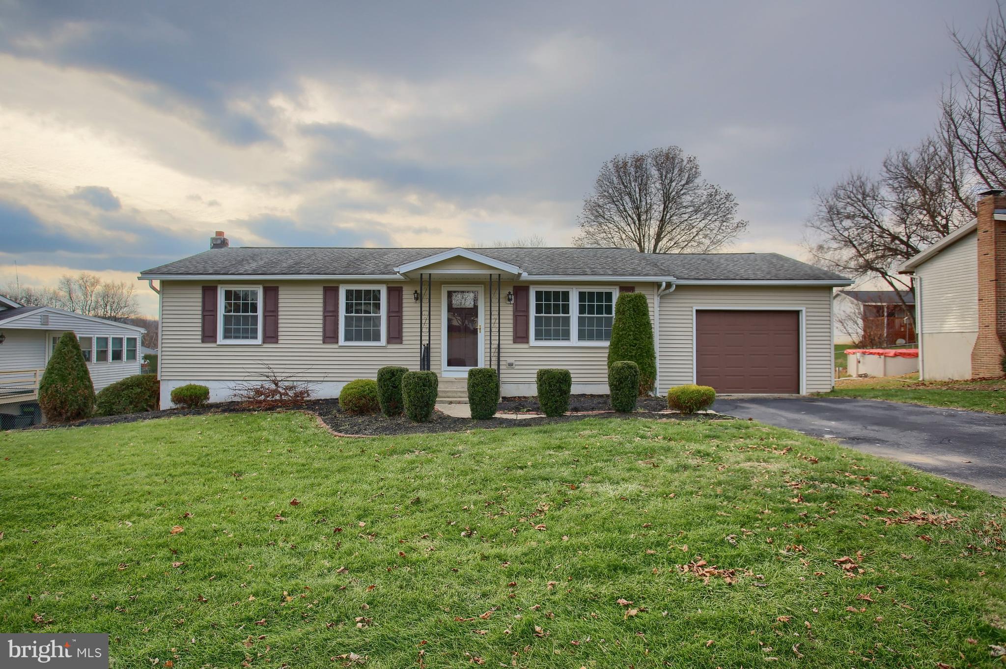 Your hunt for one floor living stops here in this cozy and meticulously cared for home. Enjoy many upgrades and improvements. The exterior is expertly maintained with clean, neat landscaping, newer roof and siding (both less than ten years old), replacement windows, new steel garage door and decorative front door, gorgeous 18 x 10 covered deck, and a level rear yard with mature shrubs. Step inside and fall in love! The eat-in kitchen renovation is stunning with 42" cabinets and crown molding, granite countertops, brand new Whirlpool appliances, new light fixture, ceiling fan, and a double sink. The central air conditioning was upgraded and replaced in 2006 as was the hot water heater in 2012. The lower level makes a fabulous second living area with over 500 square feet of additional finished space and walkout access. The bathroom floor and toilet have been replaced and the entire house boasts new shades and blinds. Should you be interested in the furniture, the seller says, "Let's talk." Don't let this house pass you by. Set up your showing today!