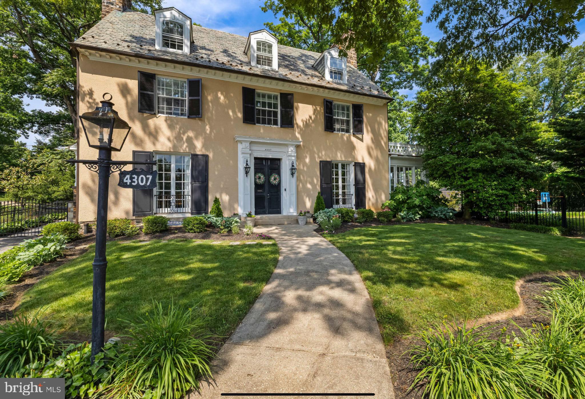 Built in 1922 in the prestigious Guilford neighborhood, 4307 N Charles Street boasts an exquisite Georgian-style residence designed by the renowned Edward L. Palmer. This incredible home offers over 5,000 square feet of luxurious living space with six bedrooms and five and a half baths, seamlessly combining classic elegance with modern updates. Upon entering through paneled double doors, guests are welcomed into a grand vestibule which leads into a large foyer boasting hardwood floors, a striking oak staircase with painted spindles, and built-up crown molding. The foyer flows effortlessly into the main living areas. The spacious living room, adorned with a gas fireplace, offers two sets of French doors that open to a sun-drenched sunroom with three walls of windows and French doors leading to the pool area, making it an ideal spot for summer parties and relaxation by the stone chimney wall's woodburning fireplace. The formal dining room, with its paneled alcove and classic pilasters, is perfect for hosting elegant dinners and adjoins to the beautifully appointed kitchen featuring hardwood flooring, a coffered ceiling, custom cabinetry, and professional grade appliances. The kitchen's wide cased portal opens to the family room where hardwood floors, built-in bookcases, and expansive windows with plantation blinds provide a warm and welcoming ambiance. The family room provides convenient access to a walk-in pantry and a powder room. The second level includes a thoughtfully designed office with heated marble flooring and a step-up flow through classic columns. The sumptuous primary bedroom suite is a sanctuary of comfort, featuring hardwood floors, custom built-in cabinetry, and French doors that open to a private rooftop area. The luxurious primary bath boasts a heated chevron pattern marble floor, a double vanity, a footed soaking tub, and a shower stall with subway tile walls and a marble bench. Two additional en-suite bedrooms and a study complete this level. The third level offers even more living space with three additional bedrooms, 2 with en-suite baths. Bedroom 4 has access to a rooftop area, providing a serene retreat with scenic views. The property sits on a professionally landscaped .86-acre lot with sprawling lawns and magnificent trees. An expansive bluestone patio, accessible from the kitchen, leads to a fenced pool sanctuary perfect for relaxing. This city oasis is great for entertaining and outdoor activities, while the electronically gated driveway ensures privacy and security. A detached two-car garage with a slate roof complements the home's exterior design. This remarkable Guilford property at 4307 N Charles Street offers the perfect blend of historic charm and modern luxury.