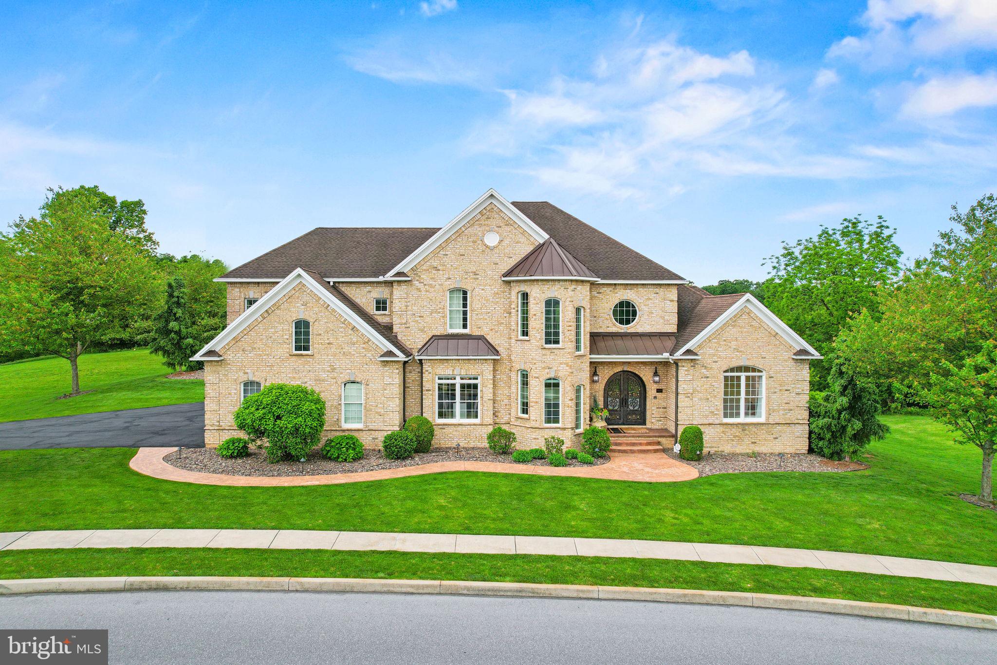 Designed for a life rooted in peace, wellness, and privacy, this refined French château-inspired estate offers a retreat that is both intentional and thoughtfully curated. Completely renovated within the past three years, the home unfolds gracefully, blending timeless architecture, natural materials, and a serene, grounded atmosphere.
Hand-forged iron doors open into a bright, expansive interior where natural light takes center stage. Sunlight pours through large south-facing windows, warming the heated travertine floors and shifting gently throughout the day. Crystal chandeliers add a refined touch without overwhelming the space, while antique Italian hardware and mahogany doors enhance and elevate the inviting aesthetic.
The two-story great room feels open yet balanced, with a strong connection to the outdoors. Walls of glass frame views of more than 30 acres of preserved green space, creating a sense of privacy and permanence while bringing nature into everyday living.
The kitchen is thoughtfully designed for both function and gathering. High-end appliances including a Wolf range, double ovens, two dishwashers, a commercial refrigerator, and a Miele coffee station are seamlessly built into custom cabinetry. Just off the main space, a private wine cellar adds a warm and inviting element.
The primary suite is set apart, offering a peaceful, elevated perspective surrounded by trees and natural light. The en suite bath is designed for restoration, featuring a clawfoot soaking tub and a multi-head purified water shower.
Upstairs, a second primary suite provides a comfortable and private space for guests, along with two additional bedrooms and a dedicated laundry area.
The lower level is centered around wellness and recovery. A marble steam room, infrared sauna, multiple showers, and a fitness studio create a space designed for both movement and relaxation. A private theater and full secondary kitchen offer flexibility for entertaining or unwinding.
Outside, a heated saltwater pool and spa blend naturally into the landscape. The expansive deck extends the living space, ideal for quiet mornings or long summer evenings.
Behind the scenes, the home is built for comfort and efficiency, with geothermal heating and cooling, a whole-home air exchanger, and integrated Control4 automation. A private elevator connects all three levels, and features such as a whole-house generator and a safe room provide an added layer of peace of mind. A four-car garage completes the property. This is a home where privacy, wellness, and everyday living are thoughtfully elevated.

Offering a rare opportunity, this exceptional property includes both the beautifully positioned .59-acre homesite and an adjacent .50-acre parcel—creating a combined 1.09-acre setting that enhances privacy, flexibility, and long-term value. Detailed information regarding the additional parcel is available in the associated documents. A separate MLS offering PADA2057962 is available for those seeking the homesite as a standalone opportunity.