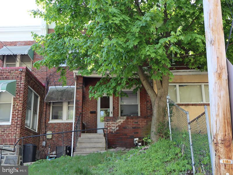 This is a two-story masonry rowhome, built in 1930 and located in the Borough of Darby, Delaware County, near the Philadelphia County line. The property features an open front porch, on-street parking, a spacious living room, dining room, kitchen, three second-floor bedrooms, a three-piece hall bathroom, and a full unfinished basement.