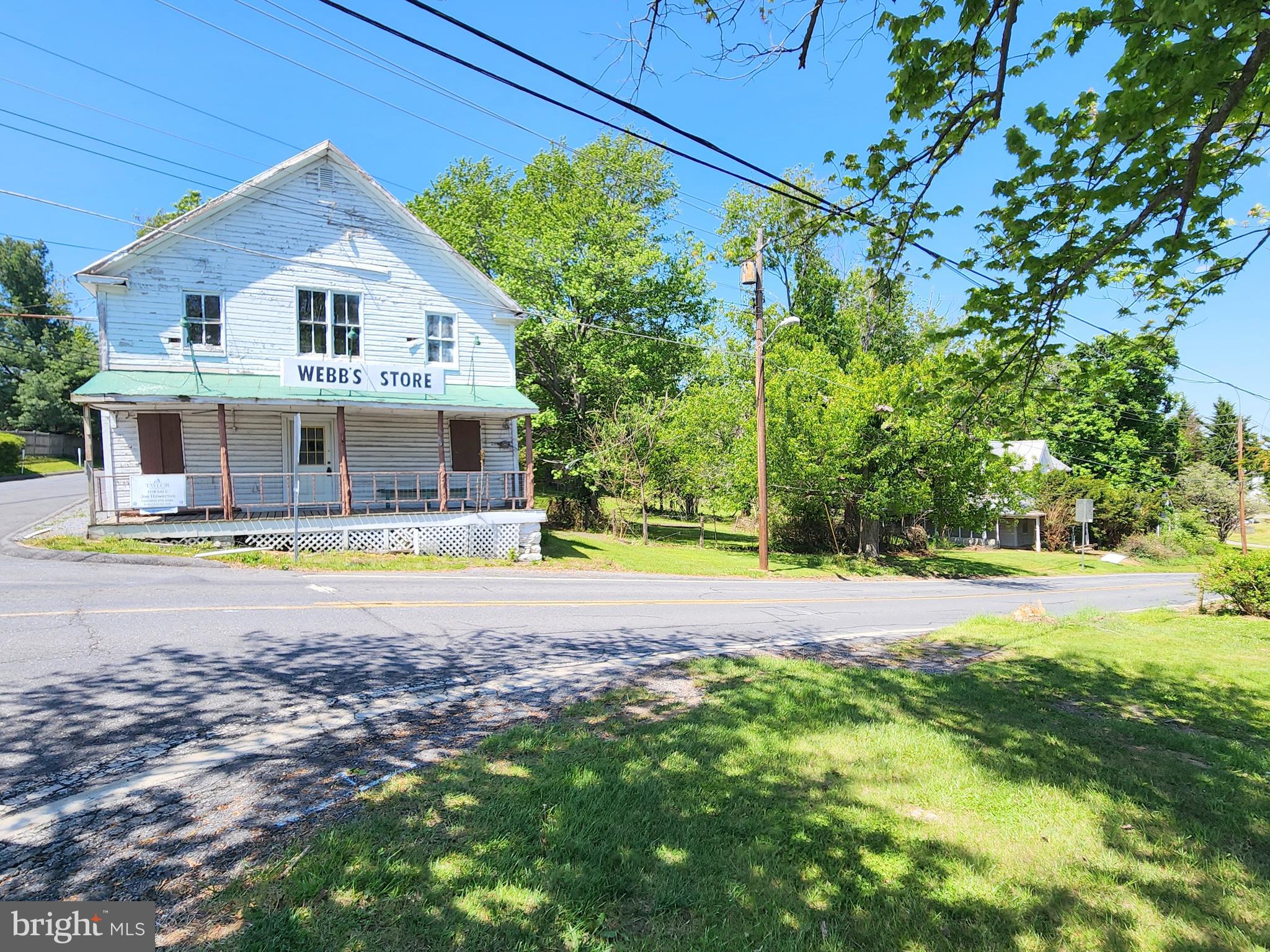 This sale includes two primary structures plus a detached garage on a level 1-acre lot.  Zoning is R-200/NR – Neighborhood Retail overlay allowing for a variety of potential residential and/or commercial uses. Webb’s Store (ca.1897), formerly A&W Grocery, served the community for over 80 years and a Victorian home (ca.1899) located next door on the shared parcel. The property is situated at a four-way stop along a heavily utilized country road that offers plenty of public exposure for your business.The corner store building is approximately 2,750 SFT and consists of a main floor with traditional general store floorplan and includes a restroom and large storage room. The upper level offers a large open space with high ceilings and additional restroom. Located just north along Clarksburg Rd, the included Victorian home is approximately 1,680 SFT and offers 3-bedroom 2 full baths. The metal roof on the home appears to have been replaced in 2008. Shared septic and well. Both structures will require extensive renovation and are being sold strictly as-is. The property is located within the Lewisdale Historic District but is not on the Historic Register. Potential buyers are encouraged to conduct their own due diligence for condition and acceptable use.