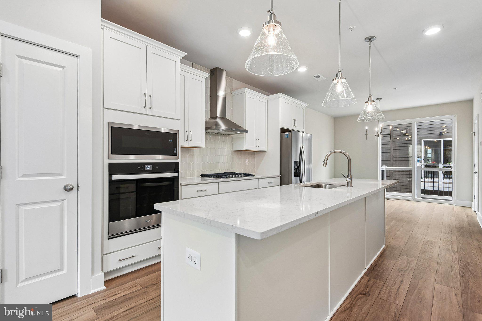**OFFERING UP TO $45K IN FLEX CASH WITH USE OF BUILDERS APPROVED LENDER AND TITLE.** MOVE-IN READY! An open-concept 4 level townhome with modern finishes and an urban aesthetic! Enter the home through the main entryway or rear load 1-car garage, both of which lead into a spacious lower level with Study and Full Bathroom. Ascending to the second level, you will discover the main living space comprised of a sunlit family room, luxury chef kitchen with an oversized island, the dining room is complete with a sliding glass door and rear deck access. When it's time to relax, retreat to the primary suite, a private getaway that can be found on the third level of the townhome. Spacious by design, this suite offers two large closets and a spa-like bath room complete with a dual sink vanity, private water closet, and shower with bench. The laundry room is also located on the third level, conveniently accessible from the primary suite and secondary bedroom. Enjoy stunning views from the fourth level's loft deck, a private outdoor living area perfect for entertaining. The fourth floor offers a 3rd bedroom and full bathroom, spacious rec room with wet bar. ***THIS PROPERTY MAY QUALIFY FOR THE BROWNFIELD TAX CREDIT. WHICH COULD RESULT IN UP TO A 70% REDUCTION IN ANNUAL CITY PROPERTY TAXES FOR TEN YEARS***
