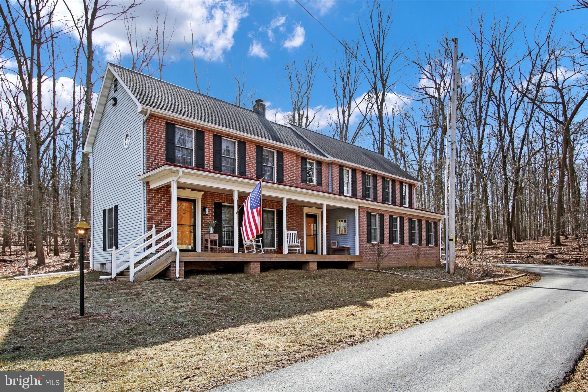 Come experience the tranquility of the woods, breathe in the fresh country air, and enjoy the wildlife surrounding you! Drive down your private 900-foot driveway, pull into the convenient two-car attached garage, and step into your beautifully maintained colonial-style home. Set on over 15 acres of serene countryside (enrolled in the Clean and Green program), this rare brick beauty, nestled on a large wooded lot, is in good condition from top to bottom. The original home, built in 1992, is complemented by a spacious addition in 2017, which includes a double-car attached garage.   This home features crown moldings, chair rails, and wainscoting throughout, along with stunning hardwood floors in excellent condition. The kitchen boasts granite countertops and gorgeous cherry wood cabinetry. Recent upgrades include a new pressure tank, filtration system, and stainless steel well pump installed in 2022. The home is equipped with two heating and A/C zones, with supplemental propane heat on the 1992 side and an exterior wood-burning furnace that circulates heated water throughout. The water heater was replaced in 2017, and the A/C units were updated in 2015 (original side) and 2017 (addition).  This exceptional property is a true gem and won’t last long! Enjoy a covered front porch, a private off-road location, and a long stone driveway. The large shed and chicken coop will remain. The two-car garage even features a convenient slop sink.  The land consists of 1 acre for the home, 1.79 acres of tillable land, 2.32 acres of residual land, and 9.98 acres of woodland. It is enrolled in the Clean and Green program, with a land use classification of 921 F, Rural Residential with Acreage, and a property class of Farm.