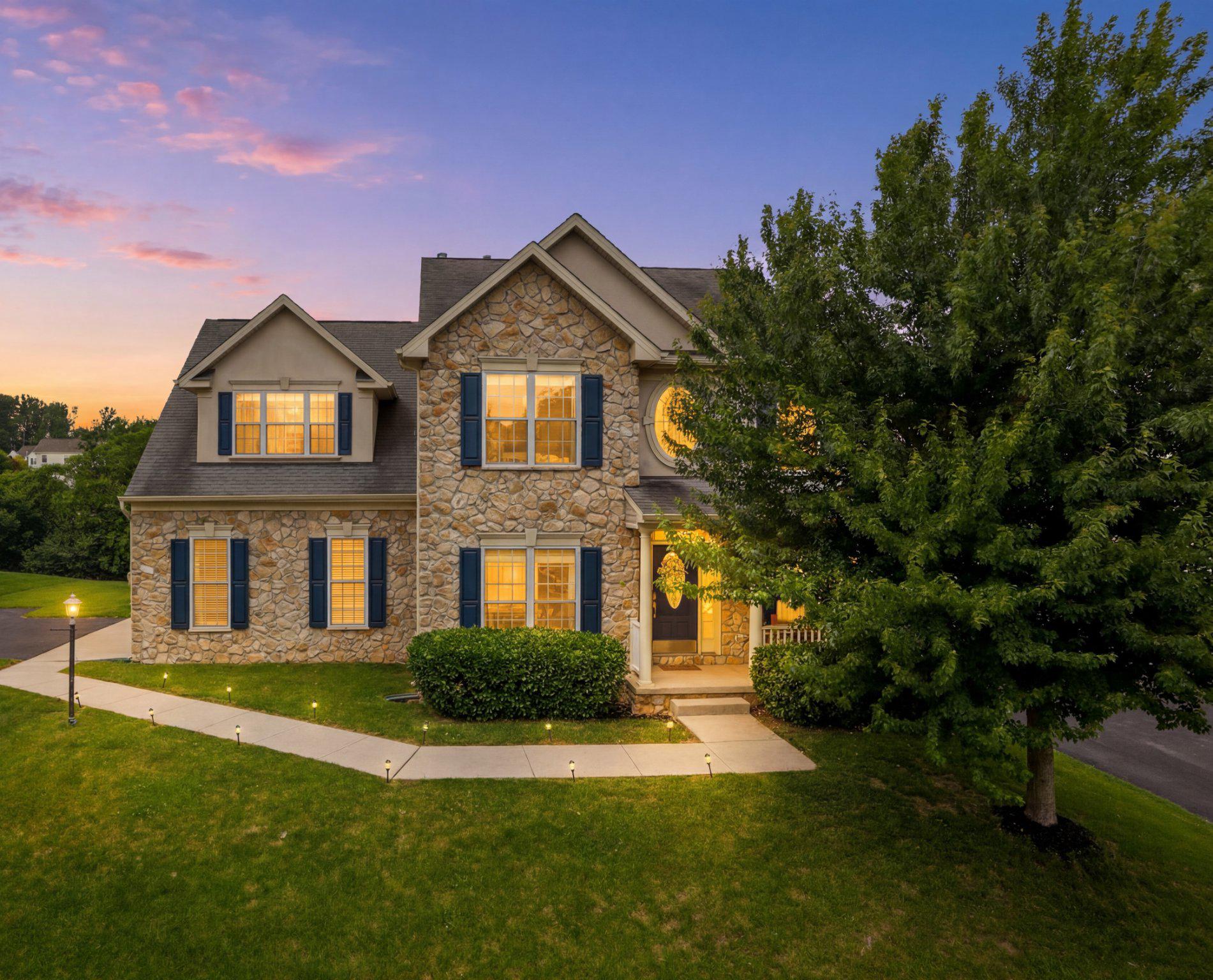 Luxury, space and thoughtful upgrades come together beautifully in this exceptional home. From the striking stone façade and welcoming front porch to the elegant interior finishes, every detail has been designed to impress. Step inside the dramatic two-story foyer, where a stunning oculus window fills the space with natural light and beautiful true hardwood floors flow throughout the main level. A private first-floor office with glass French doors offers the perfect work-from-home setup, while the updated powder room and convenient main-level bedroom add flexibility for guests or multigenerational living. The breathtaking two-story family room is the heart of the home, featuring a soaring ceiling, floor-to-ceiling stone gas fireplace, crown molding, and recessed lighting. The open, centralized gourmet kitchen is a chef’s dream, appointed with GE Profile stainless steel appliances, double wall ovens, built-in cooktop, custom tile backsplash, Corian countertops, oversized center island, double pantry, brushed nickel fixtures, and an expansive dining area, perfect for entertaining. A bright breakfast room with bay window leads to the fabulous sunroom through elegant glass double doors and double transom windows on both sides, creating a warm, sun-filled retreat. Upstairs, hardwood flooring continues throughout the 2nd level, where the luxurious owner’s suite feels like a private sanctuary. Highlights include a cozy second fireplace, TV nook, sitting area, dramatic cathedral ceilings, and three closets—including two walk-ins. The spa-inspired en-suite bath features tiled floor, dual vanities, a walk-in shower, jetted corner soaking tub, and recessed lighting. Three additional generously sized bedrooms, a 2nd full bath with double sinks, and an oversized second-floor laundry room with folding station, linen storage, pocket doors and included Samsung front-load washer/dryer complete the upper level.
The expansive partially finished walk-up basement offers incredible potential with a finished recreation/workout area, oversized utility sink, full bath rough-in and endless possibilities for future customization. Outdoor living is equally impressive with a flat yard area beside a 350+ sq ft private deck backing to mature trees and the community’s private walking trail—perfect for relaxing or entertaining in a peaceful setting. Additional premium upgrades include dual zone HVAC with Nest smart thermostat, a solar EV charger, tankless water heater, whole-house humidifier, radon mitigation system and bonus second refrigerator. This is luxury living with an exceptional open layout offering comfort, elegance and modern convenience. Schedule your showing before this rare model is gone.