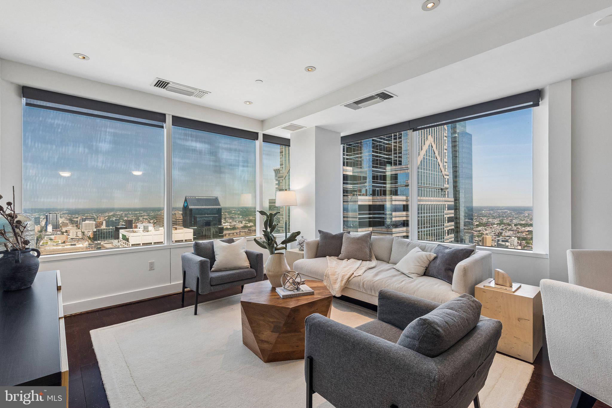 THE VIEW BELONGS TO YOU! - Enjoy spectacular panoramic city views from this magnificent corner two bedroom residence in the sky. The living and dining areas feature soaring ceiling heights, gleaming hardwood floors and walls of windows offering some of the most breathtaking skyline and sunrise views of the city. The chef’s kitchen showcases granite countertops, SUB-ZERO and MIELE appliances, and a convenient breakfast bar. The primary bedroom suite is generously proportioned and features ample closet space and an en-suite marble bathroom with double ceramic sinks and storage vanities, soaking tub, and a separate shower with glass enclosure. An included on-site STORAGE UNIT, custom built-ins, and designer finishes complete pet friendly home at the Residences at Two Liberty Place. Association fees encompass a 24-hour concierge, chauffeur-driven car service, and access to a premier amenities floor featuring a state-of-the-art fitness center, an endless pool, a yoga studio, steam showers, and saunas. Residents will relish the lavish lounge with an entertainment area, gourmet kitchen facilities, card room, and conference rooms. Perfectly situated in the coveted Rittenhouse Square/Avenue of the Arts area, this pet-friendly residence is mere steps from fine dining, exclusive shopping, world-renowned cultural destinations, and vibrant nightlife.