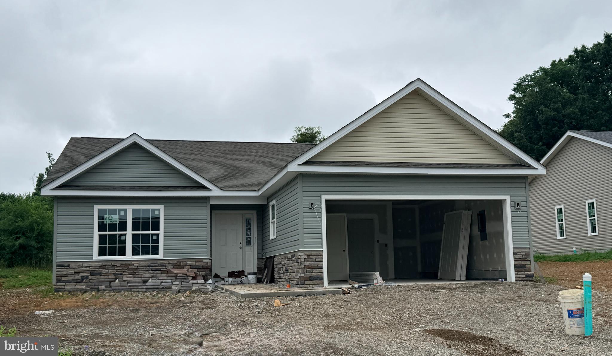LAST CHANCE! Experience exceptional single-level living in The Lakes at Martinsburg, one of Berkeley County’s desirable new home communities. This is the last brand-new single-level home offered for sale. Located on a corner lot, this home features  approximately, 1,650 finished sq. ft of living space, a spacious 2-car garage, and a beautifully flat lot, approximately 1/4 of an acre—perfect for easy outdoor enjoyment. Inside, you’ll find 3 bedrooms, 2 full bathrooms, and a dedicated laundry room with upgraded cabinetry for organized storage. The kitchen showcases upgraded white cabinetry, durable quartz countertops, and modern LVP flooring throughout—no carpet anywhere, offering low maintenance and high style. The covered rear patio extends your living space and is ideal for relaxing or hosting gatherings.
Located on the north side of Berkeley County, WV, this home offers excellent convenience for Maryland commuters, with quick access to major routes and everyday amenities. Enjoy the added advantage of lower West Virginia real estate taxes compared to Maryland, making this an appealing option.
Community amenities are a true highlight, including a fenced-in dog park, a fenced playground, and a covered pavilion picnic area—perfect for outdoor leisure, fresh air, and year-round enjoyment.