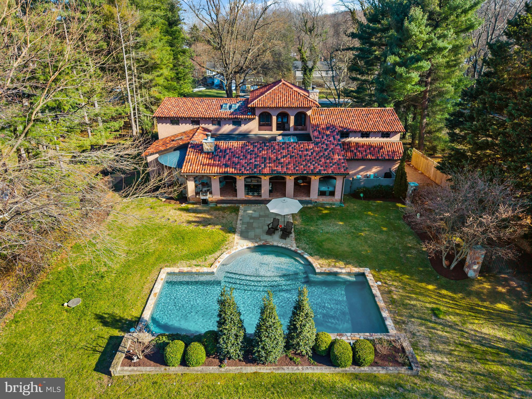 Old-world elegance is masterfully expressed in this exceptional Villa, a true work of art set on a lush and private 1.26-acre homesite just one block from the Chesapeake Bay. A rare offering that seamlessly blends timeless European craftsmanship with modern luxury, the residence is defined by hand-chiseled stone, classic stucco, and a striking terracotta tile roof, creating a presence that is both refined and enduring.

Inside, exquisite finishes and thoughtful design unfold at every turn. The gourmet kitchen is appointed with honed granite surfaces and chef-grade stainless steel appliances, while reclaimed hardwood flooring and imported Italian tile add warmth and authenticity throughout. Custom doors, windows, and plantation shutters further elevate the home’s character. The spacious primary suite offers a serene retreat with soaring 10-foot ceilings and a spa-inspired bath, while three additional bedrooms and well-appointed baths provide comfort for family and guests alike. A versatile bonus suite above the two-car garage, complete with a half bath, offers ideal flexibility for an in-law suite, guest quarters, or private office.

Outdoor living is equally captivating. A grand loggia invites year-round enjoyment, centered around a stunning wood-burning fireplace set within a handcrafted stone façade, the perfect ambiance for quiet evenings or entertaining under the stars. The resort-style backyard features a heated 40' x 18' PebbleTec saltwater pool with an elegant fountain feature, all surrounded by an expansive, level lawn framed by mature trees, creating a sense of total privacy and tranquility.  The bucolic setting just minutes from shopping, dining, and major routes, this property offers a rare blend of peaceful countryside living with everyday convenience. The grounds feature a charming pasture with shed currently home to sheep, a thoughtfully designed chicken coop, and a solar panel field beyond, adding both character and efficiency. Flexible in nature, the land invites a range of uses, perfectly balancing rural charm with modern-day versatility.

Just moments away, Safe Harbor Marina provides the waterfront lifestyle with a full-service, resort-like atmosphere. Thoughtfully designed for both convenience and enjoyment, the marina offers a seamless boating experience complemented by beautifully maintained grounds, gathering spaces, and amenities that make it easy to spend entire days on the water. From relaxed afternoons by the pool to effortless dockside access, it serves as an extension of the home, providing a vibrant yet refined setting for both recreation and connection. 

Ideally located within the sought-after Broadneck School District, the property also provides easy access to the natural beauty of Sandy Point State Park, seamless travel across the Bay Bridge to the Eastern Shore, and a direct route to Washington, D.C. via Route 50. Welcome Home!