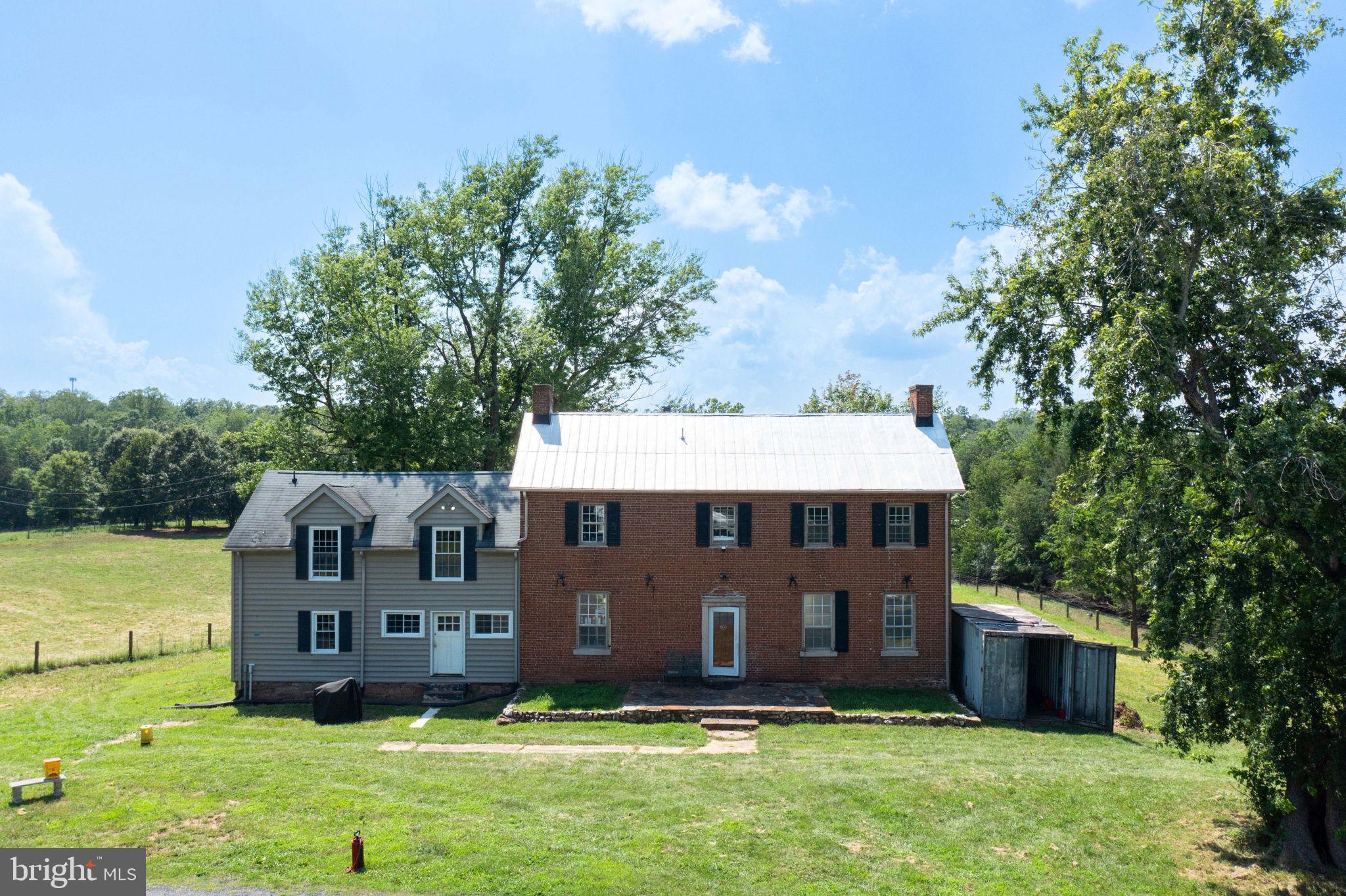 Discover a rare opportunity to own a property steeped in history and rich with agricultural potential, set along scenic Mountain View Road. Spanning 233 acres, this remarkable estate offers both heritage and versatility, making it ideal for restoration, recreation, or working farm use.

At its heart is a historic home built in 1790, once used as a Civil War hospital for both Union and Confederate troops. While filled with character, the home is not registered with the National Park Service—allowing complete freedom to restore, renovate, or reimagine the space to suit your vision. The layout offers the potential for four bedrooms and two bathrooms (including a rough-in), and features HVAC, running water, and a working toilet, with the washer and dryer conveniently located on the main level. A below-ground storm shelter adds a key safety feature to the property, providing secure protection during severe weather events. The adjacent lot features a Verizon cell tower, ensuring strong signal coverage, and approximately $50,000 in USDA-upgrades are ready to be applied for. Please note that this grant is not transferable to new owners; however, the current owners are willing to assist the future owners in applying for and securing the grant through the appropriate channels.

Two wells support the property—one dedicated to the home, the other for agricultural use—and a peaceful pond adds charm to the backyard landscape.

The land itself is a true standout. Enrolled in the PDR program with the potential for a 3-lot perk, the farm includes 12 fully fenced paddocks with electric fencing and waterers, professionally installed in 2022. Approximately 60 acres are fenced. The fencing is premium Stay Tuff Fixed Knot fencing with double hot wire. In horse pastures, the hot wire is positioned at the top and chest level; in goat pastures, it's placed at knee and chest level. The fencing, which spans approximately one mile, also creates a continuous riding trail around the property. This includes a dedicated fence road, wide enough for truck access, making it easy to maintain fencing and monitor pasture health. The land was partially timbered in 2021, offering future timber value. A 3-stall barn and a secondary barn currently functioning as a nursery with stalls provide flexibility for equestrian or livestock use. Infrastructure is in place for a potential 100x200 riding arena, and the property supports a winter strip grazing setup. A 200-amp electrical breaker supports the farm’s operations, and over $200,000 has been invested in high-quality fencing. (Buyers are responsible for maintaining the fencing or paying a pro-rated maintenance fee.)

In addition to its agricultural strengths, the property boasts a rich natural environment. Multiple creeks wind through the land, including Town Run Creek—known for its wide, deep flow—and the scenic Anderson Creek, which features picturesque waterfalls and mini rapids. The woods are filled with wildlife, including deer and turkey, and offer an extensive network of trails perfect for hiking, horseback riding, or dirt bike adventures. Some trails are already established and ready to explore, including trails that lead back to the power lines and along the creeks, while the expansive acreage offers limitless potential for creating more. Outdoor enthusiasts will appreciate the recreational opportunities, including hunting, with the current owners earning $6,000 from deer hunting alone.

Whether you’re envisioning a working farm, a private estate, or a unique historic restoration, this exceptional property offers endless possibilities—past, present, and future.