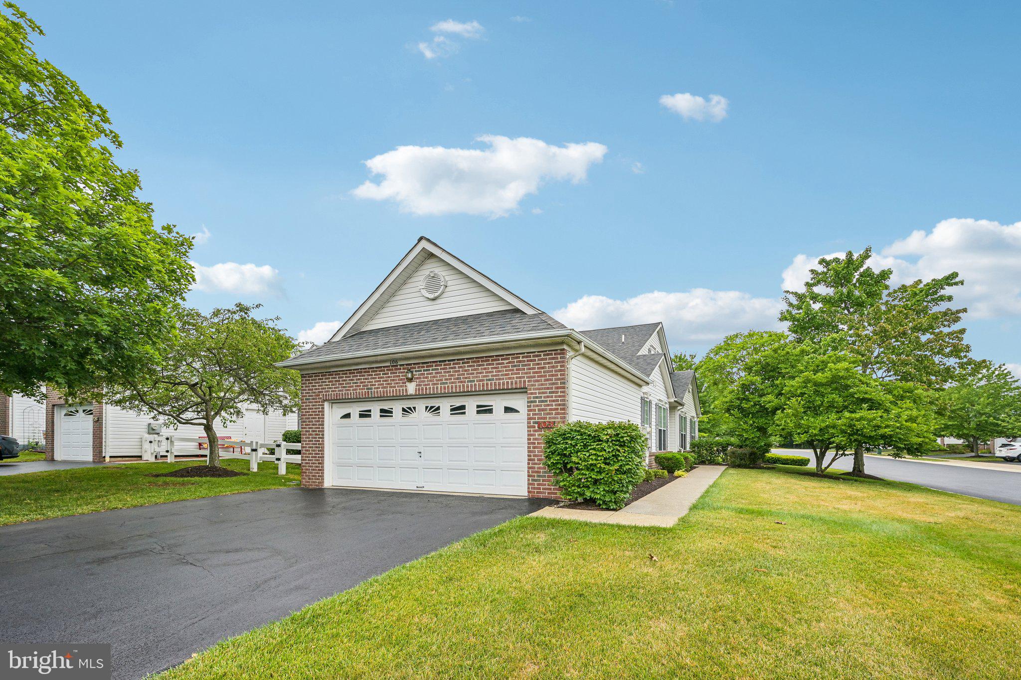 Welcome to this lovely and spacious end-unit home, perfectly situated on an expanded corner lot in the highly sought-after 55+ community of Village at Newbury. A private side entrance welcomes you into a thoughtfully designed floor plan that offers the ease of one-floor living with flexible additional space upstairs. The inviting dining and living rooms flow seamlessly together, creating an open and airy atmosphere that's ideal for both everyday living and entertaining. The living room is highlighted by vaulted ceilings and a cozy fireplace, providing the perfect gathering space. The eat-in kitchen features stainless steel appliances, a charming breakfast nook, and plenty of workspace for preparing meals. Just off the kitchen, the laundry room serves as a convenient mudroom with direct access to the attached two-car garage. The main level includes two generously sized bedrooms, making everyday living exceptionally convenient. The spacious primary suite boasts vaulted ceilings, dual closets, and a private ensuite bath complete with a dual vanity and walk-in shower. A second bedroom is serviced by a full hall bathroom. Upstairs, you'll find a versatile third bedroom/flex space ready to fit your lifestyle. Whether you envision a bedroom, sitting room, home office, fitness area, or hobby space, the possibilities are endless. A full hall bathroom on this level adds even more flexibility for guests or extended stays. This home has been thoughtfully updated for peace of mind and modern convenience, including a new roof (2025), new hot water heater, new Samsung refrigerator, new high-tech range hood with exterior venting, and an EV hookup with a Tesla charger. Offering comfort, versatility, and an unbeatable location within one of the area's most desirable active adult communities, this exceptional home is ready to welcome its next owner.