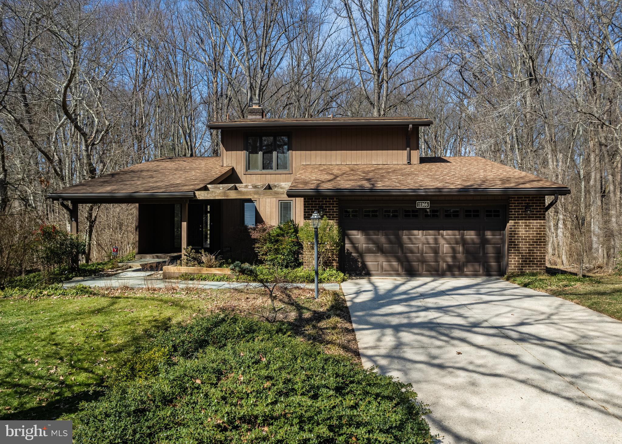 Unique opportunity to own a 1970's modern contemporary on .45 ac lot in one of Columbia's most sought-after communities, and nearby golf course - Hobbit's Glen. This home has been owned by the same family for nearly 40 years. HVAC, Roof and windows (Pella) have all been replaced.  Four bedrooms/2 baths on upper level, with possibility of a 5th bedroom on the (walk-out) lower level. Main level has original hardwood floors and a double-sided wood burning fireplace open to a cozy step-down area that can be used for practically anything.  Vaulted ceilings in living room and exposed beams in updated kitchen adds to the 70's vibe.  Private small deck off living room overlooking trees, and a screened in porch off kitchen allows for lots of outdoor living. Primary suite has walk-in closet and private bath. Another full bath downstairs and finished recreation room, a huge, finished storeroom with built in shelves and an unfinished area great for a woodshop. Large 2 car garage with tons of storage. Separate laundry room on main level. HOA = CA (Columbia Assoc) $1483 paid annually and is usually escrowed in mortgage.  Home has oil heat (newer tank in basement) but natural gas has been run to the house and can easily be re-installed. Freshly painted throughout.