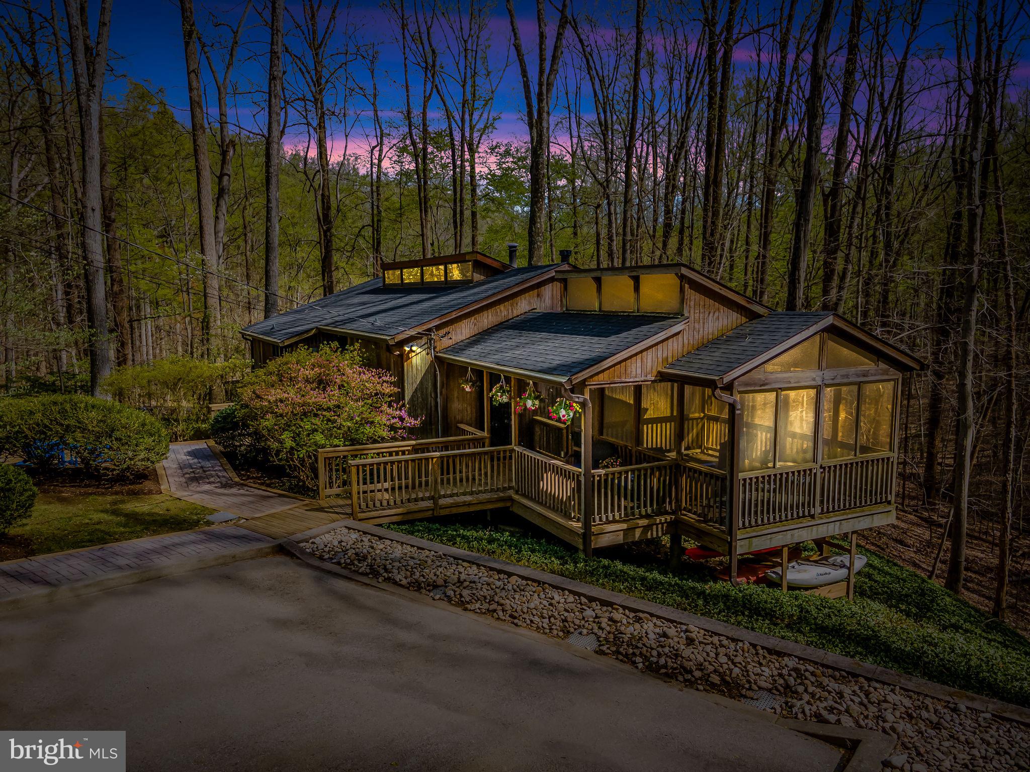 REQUEST FOR OFFER DEADLINE-HIGHEST AND BEST DUE 4/20 AT 3 PM! Architect-designed mid-century contemporary home privately sited on 3.74 wooded acres, blending timeless design with thoughtful modern updates. Located down a secluded driveway, this open-plan home features soaring cathedral ceilings with post-and-beam construction, tongue-and-groove wood ceilings, and clerestory windows that bring in abundant natural light. Expanses of Marvin replacement windows and doors provide serene tree-filled views from every room.

The main level features a spacious Living and Dining area with a freestanding fireplace, an open Kitchen, and seamless access to newly rebuilt decks and a stunning wraparound patio (2023)—ideal for indoor-outdoor living. Refinished hardwood floors (2022) span the main level. The Primary Suite includes updated lighting (2023), and an adjacent bonus room offers flexibility as a home office, laundry, or mudroom. A charming screened sleeping porch adds to the livability.

The walk-out lower level includes a bright Family Room with sliding doors to a grade-level deck, three additional Bedrooms, and an updated full Bath. New luxury vinyl plank flooring was installed in the Kitchen and lower level in 2022. Additional features include art lighting (2023), custom closet systems (2023), and a hot tub (2023).

Enjoy direct access to walking trails leading to Loch Raven Reservoir, offering scenic outdoor recreation right from your doorstep.

Extensive mechanical upgrades include:

Tankless water heater (2024)
Bryant HVAC with major service and new thermostat (2024); system installed 2014 by Pipco
Roof and gutters replaced (2020)
Top driveway resurfaced (2024)
Septic pumped (2024)
New refrigerator and dishwasher (2022)
Dog fence installed (2023)

A custom Rogue Valley raised-panel front door with Baldwin hardware enhances the entry. Driveway parking for multiple vehicles. This special property offers exceptional privacy, architectural integrity, access to nature, and a long list of quality updates—ready for its next chapter.