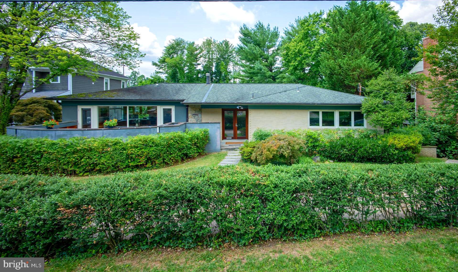 A very special offering in Kenwood Park, this rare and deceptively large 5-bedroom, 4-bathroom Mid-Century Modern jewel boasts nearly 5000 square feet of enticing living space and an array of phenomenal outdoor spaces including a refreshing swimming pool, tiered decks, and unique patios. Complimenting the interior are gleaming hardwood floors, varying ceiling heights with vaulted geometry, and large picture windows which bring the outside in. Highlights of the main floor include all the essentials for one-level living: the first of two primary bedroom suites; an incredible sun filled chef’s island kitchen with walls of glass, a breakfast area, built-in desks, professional appliances, a laundry closet, and access to a wonderful walled patio; a separate dining room with iron railing overlooking the room just below; a relaxing living room offering triple window views of the pool and green setting. A few steps down, the mid-level features a spacious family room with one of two floor-to-ceiling wood burning fireplaces and glass door passage to covered and open decks outside, the second primary bedroom with an attached dual entry bathroom, two additional bedrooms, and a hall bathroom. Predominantly above grade, the expansive lower level offers a kitchenette, a large bedroom, open recreation and game areas, a full bath, and a flexible office space with direct access to a sunroom which runs poolside. A discreet semi-circular driveway, mature plantings, and a fully fenced rear yard with plentiful lawn and gardening space complete the exterior grounds. Endlessly versatile and accommodating, this retreat-style property lends itself to everyday enjoyment, year-round entertaining, and multi-generational living. 6240 Clearwood Road is conveniently located near downtown Bethesda and Washington DC and in the coveted Burning Tree/Pyle/Whitman school districts. Welcome home! (Sq ft & ceiling height calculations provided by Arcdimension/deemed reliable but not guaranteed).