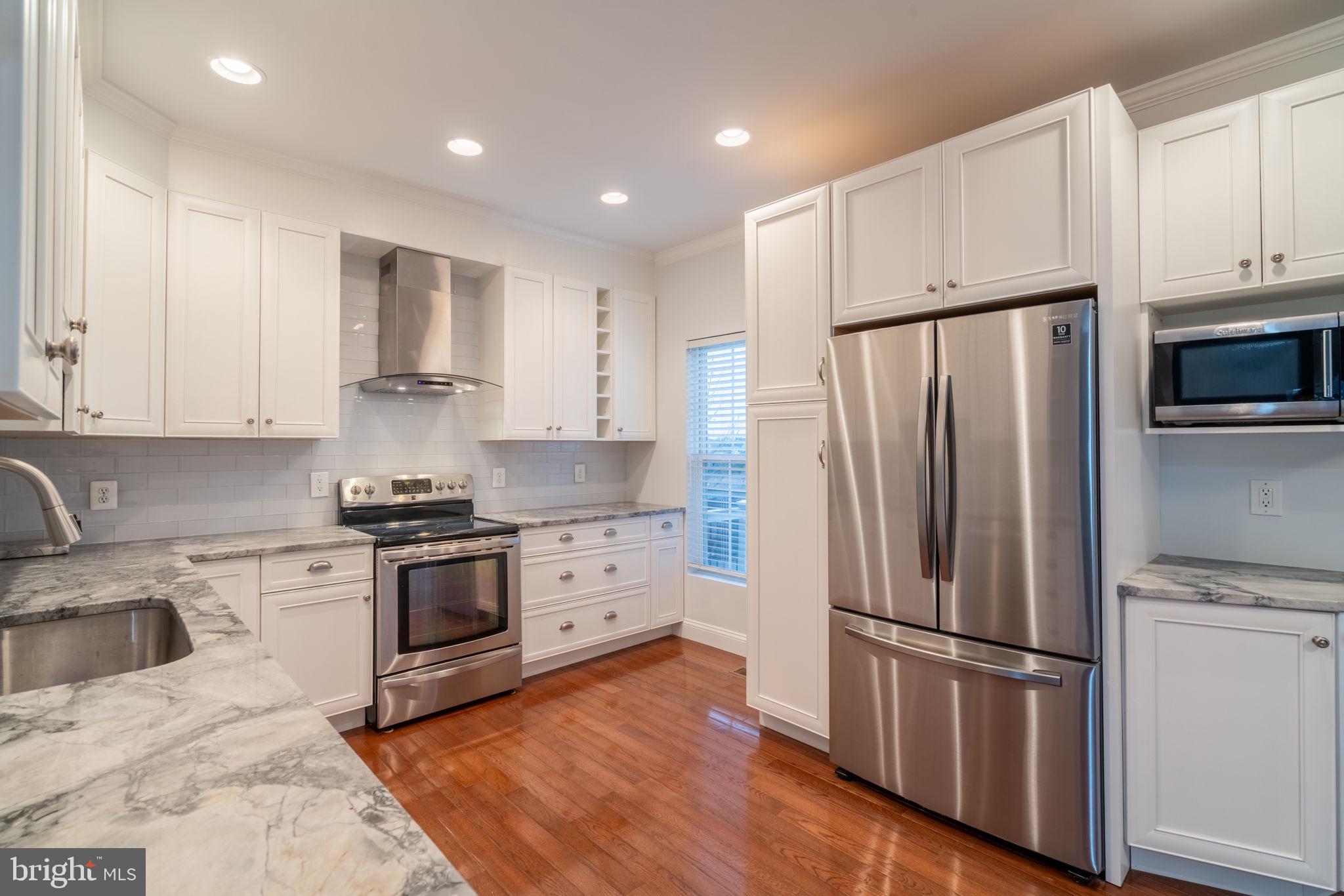 Gorgeous fully renovated Townhome. Impeccably updated with newer Hvac, hot water heater, newer trex deck and lower deck.  Main level includes large open floorplan with hardwood floors throughout, beautiful hardwood stairs, plantation shutters. Gourmet kitchen with high end soft close cabinets, pantry style add on cabinetry with pull out drawers,  beautiful granite counters, decorative backsplash, stainless steel high end appliances including high efficiency range hood. Large primary bedroom with newly renovated primary  bath with oversized shower, upgraded ceramic tile, vanity with double sinks. Ceiling fans in all bedrooms. New luxury vinyl plank flooring in lower level and secondary bath. Updated lighting throughout. This home is a perfect 10!!!