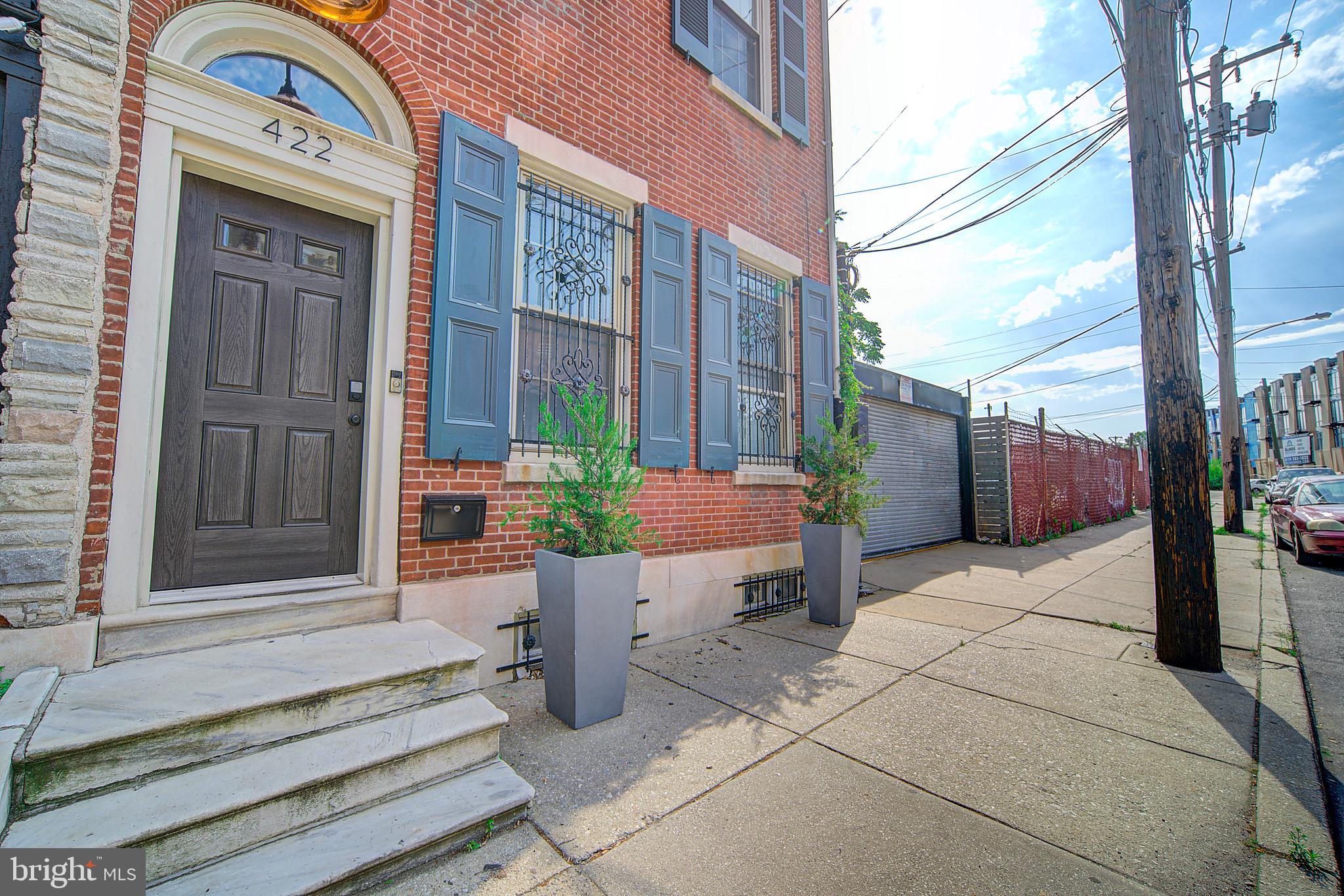 Enjoy your private sanctuary without giving up the perks of the city   this recently renovated 1840s home sits on a rare double lot, with a yard, shade and fruit trees, flagstone patio, and two-car garage with cobblestone driveway in Northern Liberties, around the corner from shopping, dining, parks and public transit. The crisp, open kitchen is fully renovated, with Caesarstone and granite counters, radiant floor heating, Sub-Zero/Miele appliances, and opens onto your huge private patio and cedar-fenced yard. The spacious living area on the main level features original pumpkin pine floors that have been upgraded with radiant floor heating, 11  foot ceilings with exposed beams, gorgeous light fixtures, and an incredible wood-burning fireplace, which includes original tilework you won t find in a new construction home. Head up the original, open staircase to a fully renovated bathroom with beautiful double vanity countertop, freestanding tub and separate glass shower. Two bedrooms on the 2nd floor feature 11  ceilings and huge windows that offer tons of light, closet space and another wood-burning, original brick fireplace. Continue up the open staircase past a 3rd bedroom, nestled in the tree tops, before arriving at the newly renovated Master Suite. This elegant sanctuary features a sleek, spacious walk-in closet, vaulted ceilings, a fully-renovated private five-piece bathroom with shower, freestanding bathtub and a view onto your private oasis. The spacious finished basement adds another full bath, dedicated laundry room, and ample storage. Come and see this private, perfectly updated original gem - you will not find another home like it in Philadelphia. The home's lot size is 19 x 79 and the adjoining lot is 21 x 64. This is a must see to believe!