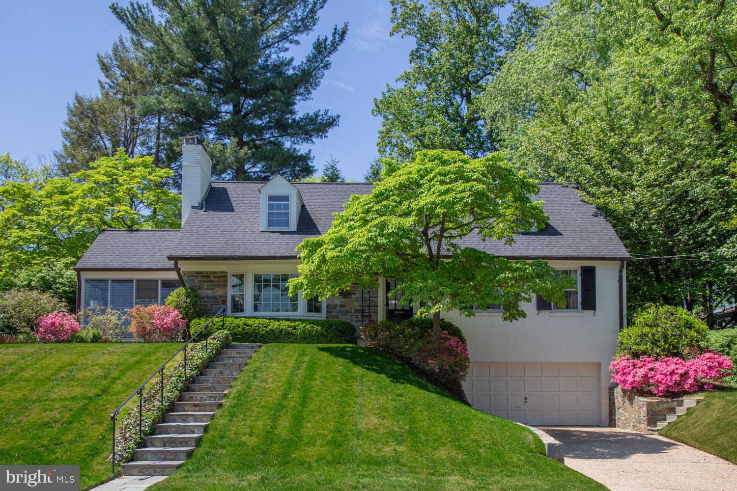 Welcome to 5016 Scarsdale Road—completely turn-key, gracious, and beautifully expanded offering more than 3,200 square feet of thoughtfully designed living space on a picturesque, nearly 10,000-square-foot lot on one of the best blocks in Sumner. Timeless in its architecture and effortless in its livability, this exceptional residence has been meticulously maintained and thoughtfully updated, with sun-filled interiors and gleaming hardwood floors throughout.

At the heart of the home is a fabulous gourmet eat-in kitchen featuring abundant cabinetry, a center peninsula, new stainless steel range and refrigerator, and an exceptional breakfast room addition with soaring ceilings and a skylights that fill the space with natural light. French doors open to a flagstone patio overlooking the professionally landscaped, private flat backyard—creating a seamless connection between indoor and outdoor living and providing the perfect setting for entertaining or quiet evenings at home.

The elegant living room, anchored by a classic fireplace, flows seamlessly into the formal dining room. Just beyond, the inviting all-season porch offers a peaceful retreat overlooking the gardens while providing effortless access to both the backyard and kitchen.

The main level offers remarkable versatility, featuring a family room with an adjoining powder room, two additional bedrooms, and a full bath. Upstairs, three spacious bedrooms, a hall bath, and abundant storage complete the level. The center bedroom is generously sized and easily serves as either a bedroom or an additional family room, offering flexibility to suit a variety of lifestyles.

The finished lower level has a spacious recreation room centered around a second fireplace with ample storage with shelving, space for a wine cellar  or additional storage, a mudroom conveniently located off the attached two-car garage, a laundry area, and an additional half bath. 

Additional highlights include an irrigation system, roof installed in 2019 with a transferable 50-year 5-Star warranty and new LVT flooring in kitchen and basement.

Perfectly positioned in the highly sought-after Sumner neighborhood, 5016 Scarsdale Road offers the rare combination of timeless character, generous living spaces, and an exceptional location. Enjoy tree-lined streets, nearby Capital Crescent Trail, parks, dining,  shopping, top-rated schools, and convenient access to downtown Washington, D.C. and the Beltway. Warm, welcoming, and wonderfully livable, this is a home designed to be enjoyed for generations. (Floor Plans and Estimated Square Footage courtesy of Floor Plan Visuals.)