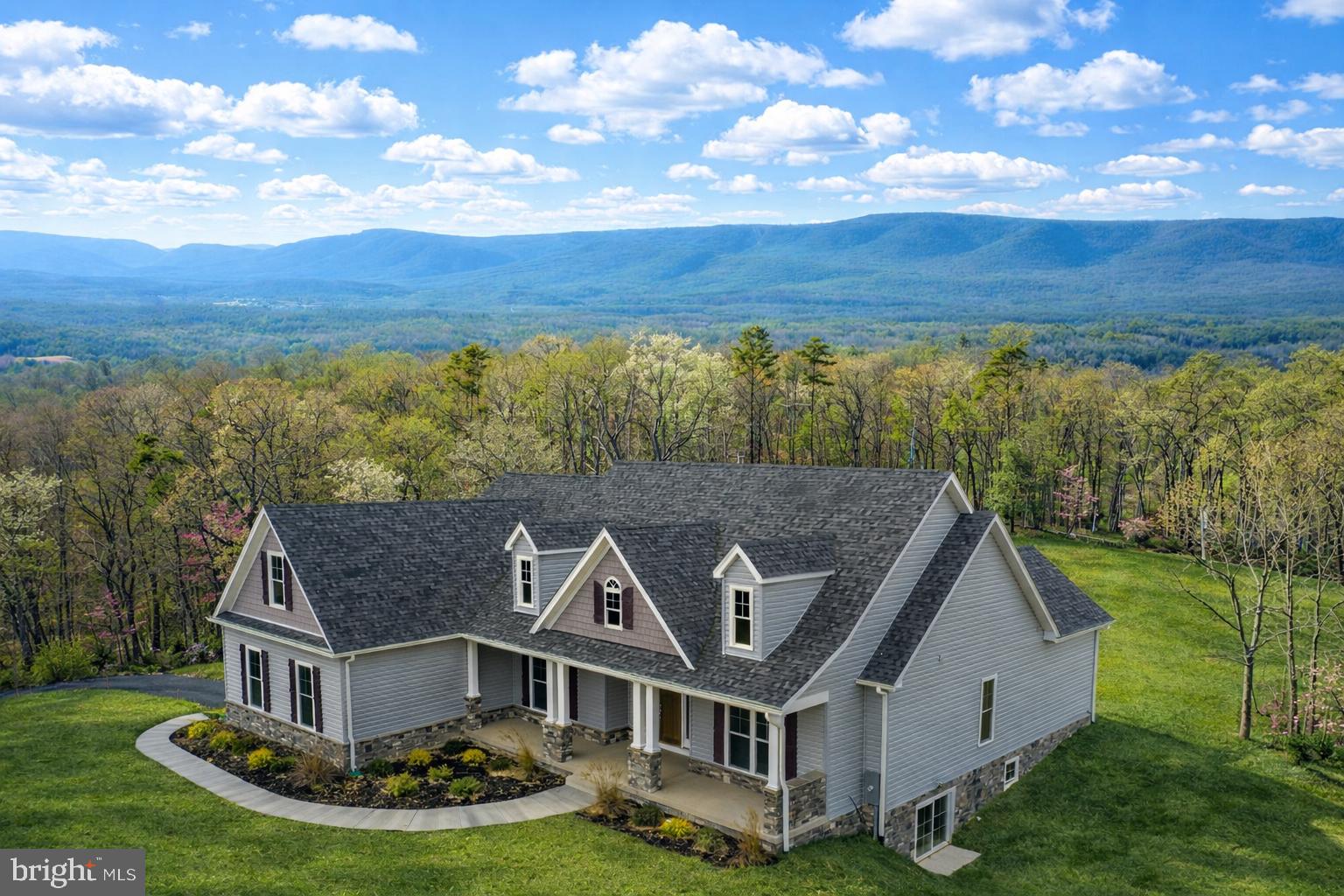 This is a rare opportunity to build a fully custom home tailored to your vision, crafted by Winchester’s award-winning builder, Hepler Homes. The home shown is a representative example of what can be built on this exceptional property. List price reflects the included options outlined in the documents section and is subject to change based on custom selections.
The featured model offers a thoughtfully designed, open-flow floor plan with exceptional base finishes that set this builder apart, including stainless steel appliances, a wood-burning fireplace, quartz or granite countertops, and high-quality craftsmanship throughout. The home includes three bedrooms, two full baths, a full basement with rough-in plumbing, and generous well and septic allowances.
The building site has already been cleared, and driveways are installed, making this a truly turn-key opportunity to begin construction. The lot has been perked for a five-bedroom home, allowing flexibility to choose an alternative floor plan if desired.

The land itself is the true showstopper.
Located less than 90 minutes from Dulles International Airport, this property offers the perfect balance of accessibility and total seclusion—ideal as a full-time residence or weekend retreat. As you wind through the forest along the beautifully engineered private road, you’ll feel fully immersed in nature.
This offering is part of a unique three-lot subdivision designed around something irreplaceable: land and the freedom it provides. The closest neighboring residence is over one mile away, yet electric service has already been brought to the lots, and professionally engineered roads provide easy, year-round access—no four-wheel drive required.
Lot 2 stands out for its unmatched privacy and jaw-dropping mountain views. The proposed homesite opens onto a breathtaking plateau, offering sweeping vistas and absolute tranquility.
Encompassing 152.44 acres of pristine, unrestricted land, the property features mature timber, healthy regenerative growth, and multiple wet-weather and year-round streams. The land is enrolled in a professional forestry management plan, providing environmental stewardship, excellent wildlife habitat, and extremely favorable tax benefits.
With over four miles of professionally installed, all-weather road and trail infrastructure, the property is easily explored and enjoyed year-round. Whether your interests include outdoor recreation, hunting, conservation, or simply enjoying the peace and quiet, this is a true nature lover’s paradise.
The land also offers potential for a family subdivision and is ideally suited for a legacy estate, private retreat, winery, agricultural use, or agri-tourism venture. The only limitation is your imagination.
The land may also be purchased separately without the home (MLS VAFV2038448) and is available as a single 152.44-acre parcel or as part of a larger 439.448-acre contiguous offering (see MLS VAFV2024650).
Shown by appointment only.