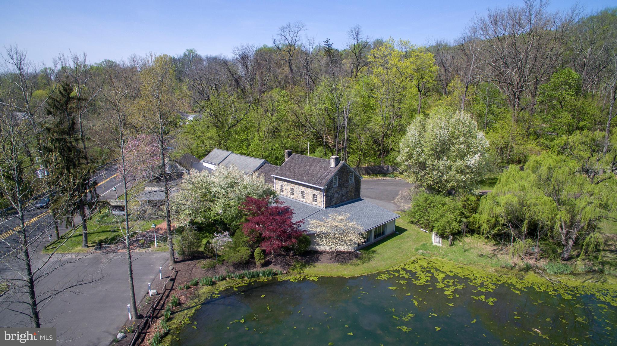 One of the most picturesque commercial properties on the 202 corridor, overlooking a large pond with fountains and frequented by wildlife such as blue herons, ducks, deer, and more, this long term corporate tenant-occupied property is great for an investor looking for stable rental income in a prime municipality where property values are premium.  Average daily traffic exposure to 18,000 vehicles and located just over the bridge to New Jersey, this complex offers a large (5,300 sq ft on the first floor alone, over 7,000 SF total) space in an affluent area that is restrictive with commercial development, with no competing buildings of this scale.  Across the road is a newer public park/nature preserve, and the property is just minutes to downtown New Hope, Doylestown, and major commuting roads to New Jersey, Philly, and NYC (the I-95/295 corridor and PA/NJ Turnpikes).   The detached two bedroom cottage in the back has a history of long term tenants, who enjoy the pool, three car garage, and scenic views.  Two parking lots (front and back), do not enter the property or approach the occupants without an appointment, consult listing agent for details and NDA.