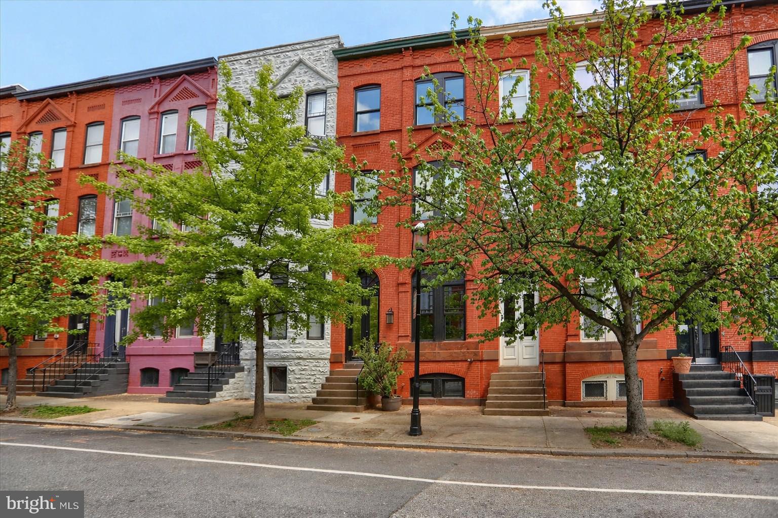 Welcome to 1811 Madison Ave, ideally situated on a quiet one-way street in the heart of Madison Park. Step inside to soaring two-story ceilings in the dramatic main living area, where exposed brick, custom tray ceilings, and a sleek linear fireplace create an unforgettable first impression.

The kitchen is a true showstopper, featuring a massive waterfall quartz island, herringbone tile backsplash, and custom cabinetry. On the second floor, you'll find a stellar loft space perfect for a family room, office, or flex area overlooking the living room, along with a luxurious primary suite complete with an oversized walk-in shower, double vanity, and freestanding soaking tub.

The third level offers three generously sized bedrooms and a stylish hall bath. The finished lower level provides exceptional bonus space ideal for a media room, gym, office, or guest retreat.

Complete with a one-car garage, rear deck, and thoughtful finishes throughout, this home delivers style, function, and convenience in one of Baltimore’s most desirable neighborhoods. Just moments from Reservoir Hill, Bolton Hill, MICA, Penn Station, and downtown, this is city living with room to breathe.