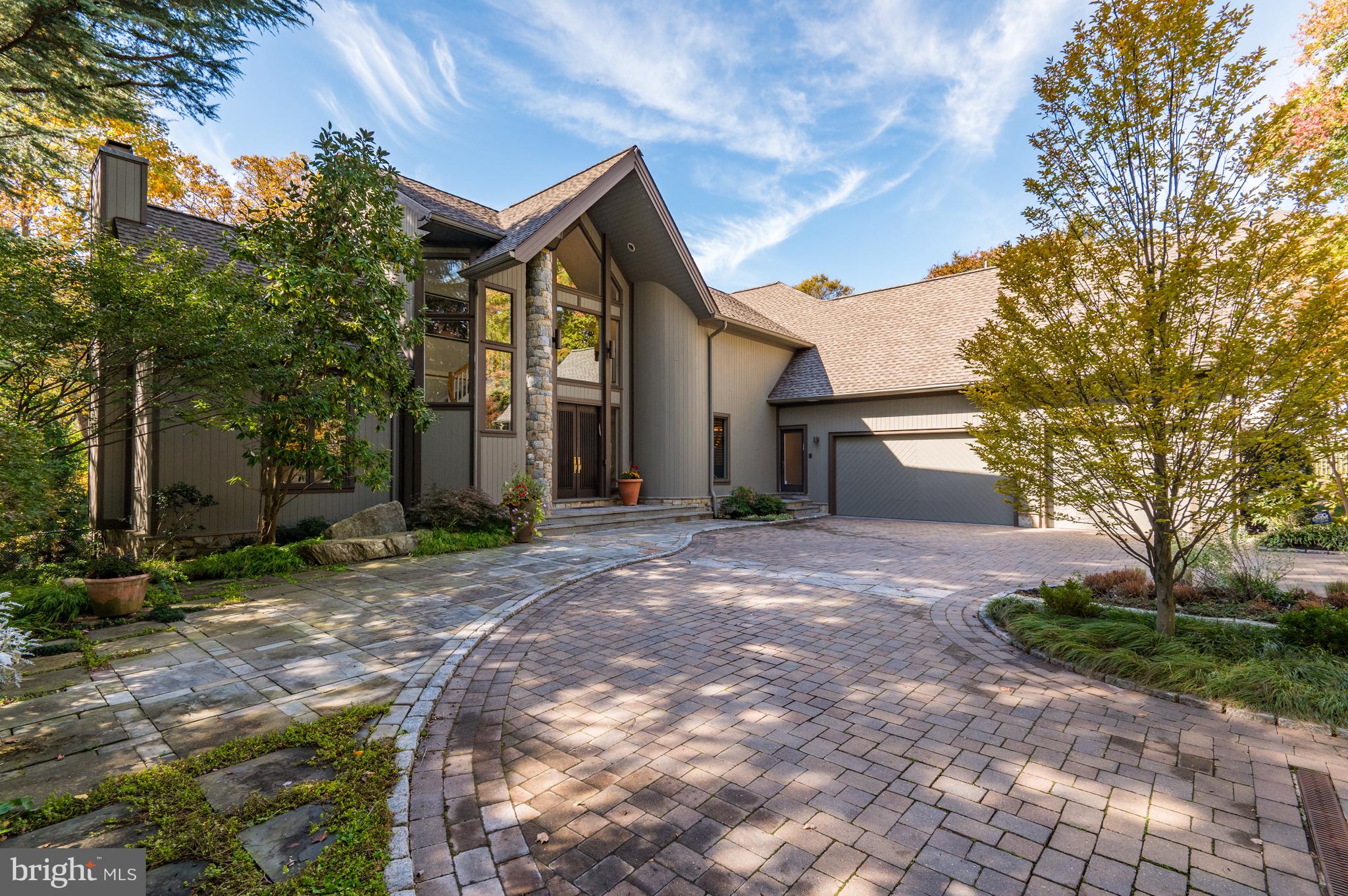 Special does not begin to describe this custom-built home! Designed for the present owners by Crowell & Baker Builders, careful thought and attention to detail are apparent throughout. A circular driveway with pavers leads to the covered-porch entry as well as a spacious three-car, side-entry garage and extra parking. Located on over three-quarters of an acre, this property is tucked away providing privacy on a well landscaped lot with a circular driveway with pavers for extra parking and side patio. 

Every inch of this unique floorplan, which features numerous interesting architectural details, is carefully designed with each room on the main level enjoying access to the foyer. The first-floor library with its 14-plus-foot cathedral ceiling is especially inviting. Its floor-to­ ceiling bookshelves enhanced by an inlay design and a gas fireplace with ceramic tile surround create a warm and inviting space. The adjacent living room has a curved alcove with windows that provides a spectacular view of the backyard and pool. Highlighting the large dining room is a curved buffet with cabinets and a glass bowl with custom faucets. The dining room also offers easy access to the kitchen, deck, and screened porch. The kitchen/family room is a wonderful informal space with plenty of room for seating around the center island as well as space for a table and chairs. The kitchen is a chef's delight with two work areas that function as two fully equipped kitchens. The mudroom/caterer's kitchen have a large walk-in pantry, washer and dryer and access to the heated, side-entry three-car garage with built-in storage components. 

A curved staircase and secondary staircase lead to the second floor with vaulted ceiling and balcony overlook. The Primary Suite was completely renovated in 2020. A foyer with a large walk-in, organized closet leads to a wonderful Primary Bedroom with custom wall-to-wall carpeting and an alcove with large windows overlooking the beautifully landscaped backyard and pool. The recently redone custom Primary bathroom features a second large walk-in organized closet, two large vanities with rectangular sinks, mirrors and lighting, a stand-alone oval tub and separate shower. There are four additional bedrooms, each with large walk-in organized closets and wall-to-wall carpeting. Two "Jack 'n Jill" bathrooms, each with tub/shower, are shared by four bedrooms. 

The finished walkout lower level provides multiple options. The lower ­level recreation room with its custom built-ins has one large storage room and an additional storage/utility room. Two additional bedrooms with two ensuite full bathrooms and an exercise room with a third full bathroom complete the lower level. Access to the backyard is available from the recreation room and the exercise room. 

The outdoors of this wonderful property does not disappoint! Enjoy the recently (2021) refurbished 20 x 40 heated pool from the wonderful screened-in porch and deck or the inviting, covered flagstone patio. There is new pool equipment, an electric cover, and winter cover.