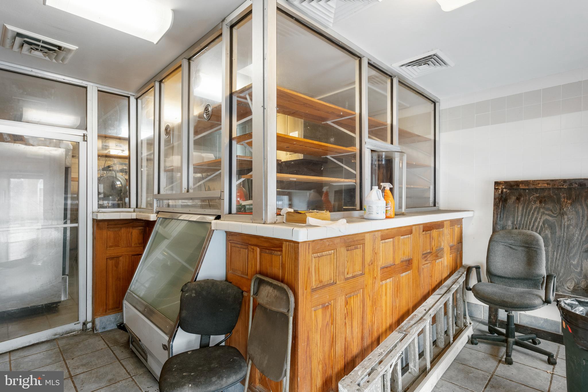 End-of-group mixed-use brick-front rowhome with income potential and charm! The main level is set up for a deli or restaurant, fully equipped and ready to go—with a convenient powder room for staff and guests. Upstairs, the residential space, which has a potential rental income of $1,500, offers an open layout with a spacious kitchen, island prep area, and room for both dining and entertaining. Natural light floods the living area through large windows. A bedroom, full bath with tub/shower combo, and laundry room complete this level. The top floor features two generous bedrooms and another full bath. Live upstairs and run your business below—or rent out one or both units for additional income! Prime location near Reservoir Hill, Druid Hill Park, Route 40, and I-83.