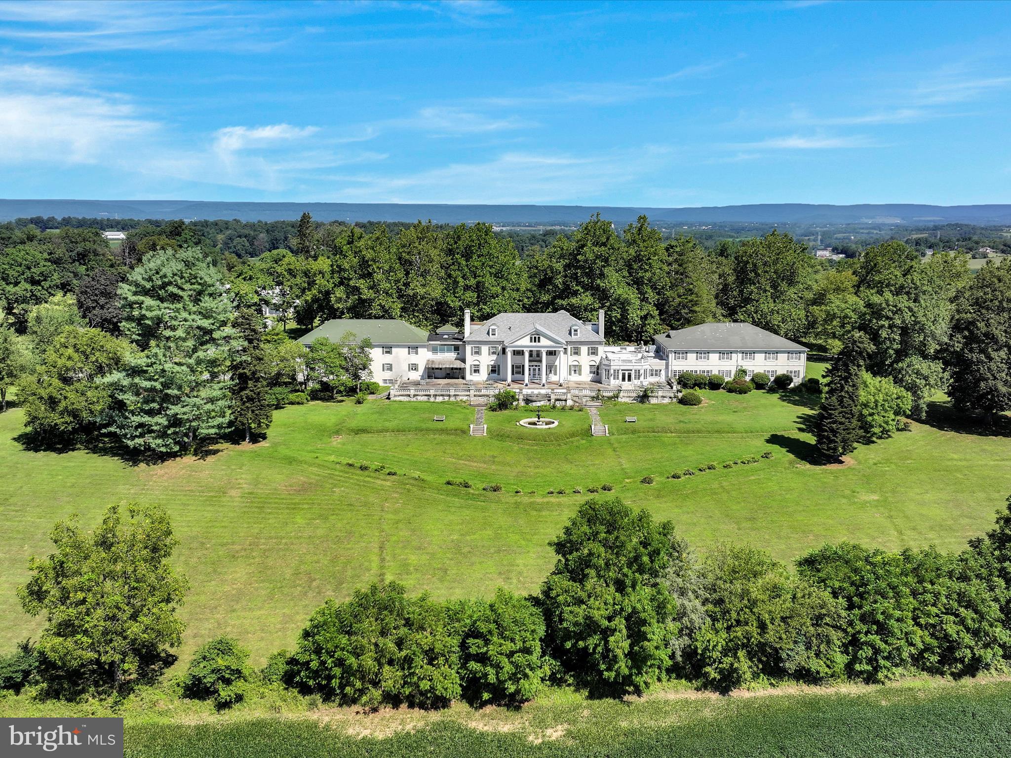 Welcome to HILL FARM ESTATE and discover the potential this historically significant 23.8-acre property has to offer! Once the private residence of U.S. Congressman and industrialist Aaron S. Kreider, this Federal-style mansion was later converted into a personal care home operating with 43 private rooms between the main & upper level, multiple common area/gatherings rooms, dining rooms, a commercial kitchen, administrative offices, a huge finished basement and even more space in the finished attic. 
The grand terrace is offering sweeping views of the scenic grounds, stretching all the way to Mount Gretna. A separate carriage house adds 7 residential units (three 2-BR and four 1-BR apartments) with 2 units currently being tenant occupied, offering immediate income opportunities. Set in a serene, park-like environment with mature trees and open green space, the property offers a rare combination of historic character and functional capacity. With existing infrastructure already in place, the estate presents a compelling opportunity for continued use as a care facility, conversion into a hospitality venue, wellness retreat, residential community, or adaptive reuse development, all subject to zoning and approvals.
Whether you're an investor seeking steady income, a developer exploring a unique project, or a visionary ready to write the next chapter for this storied property, Hill Farm Estate invites endless possibilities!