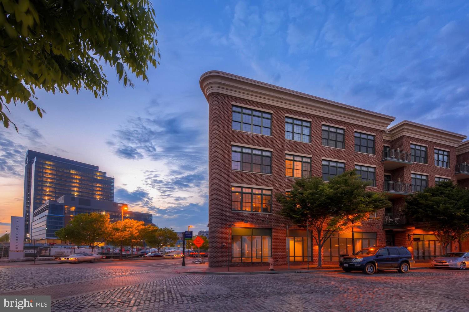Experience the ultimate in waterfront living with this stunning two-bedroom, two-and-a-half-bath condo plus loft in Fells Landing. Boasting nearly 1,500 square feet of indoor and outdoor living space, this exceptional residence offers breathtaking water and city skyline views in the heart of Fells Point.
The open-concept main level is designed for both style and function, featuring a gourmet kitchen with an oversized eat-in island that seamlessly flows into the living, dining and private balcony.  Upstairs, the mezzanine loft provides a versatile space ideal for a home office, additional bedroom, or secondary family room—all with spectacular panoramic views. Step outside to the expansive rooftop terrace, offering outdoor entertaining space and sweeping vistas of the city and waterfront. Two garage parking spaces convey, completing this remarkable offering. Live the vibrant city lifestyle with historic Fells Point charm and modern downtown convenience, just steps from restaurants, boutique shops, the Sagamore Pendry, nightlife, and the water taxi.