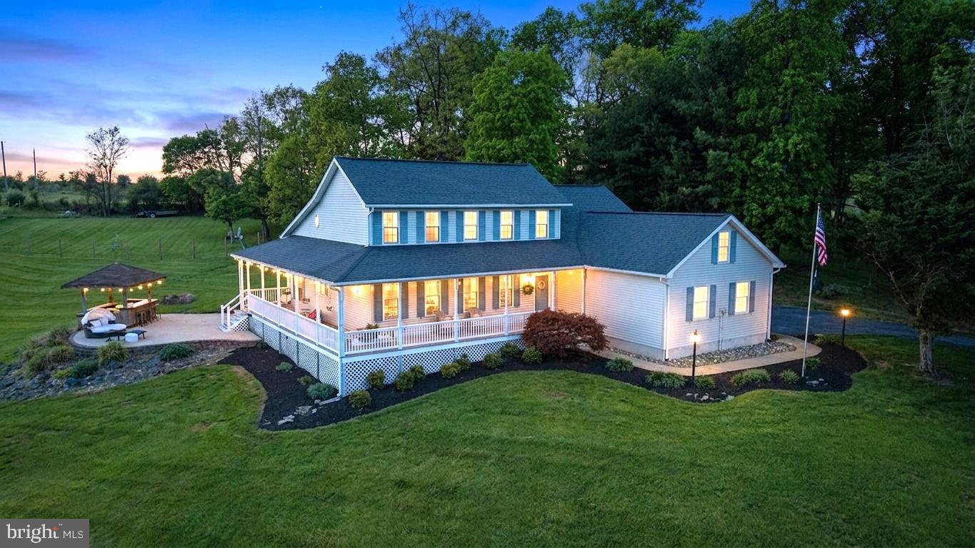 Welcome Home to This custom built Colonial on nearly 2 beautiful acres here in New Windsor, MD. The home is very charming with a unique layout and original hardwood flooring, while the setting is private and the views from the wrap around porch and patio are unmatched! The main level features a primary bedroom, full bath w/ custom shower, and walkin closet.. vaulted ceilings in the great room, skylights, a brick fireplace, granite countertops in the kitchen, formal living/dining room or private office space! The upper level features 3 additional bedrooms with connecting full bathroom. The lower level offers another 770sq ft of finished living space including an exercise room, new LVP flooring, game room, wood stove, and plenty of storage. Step out back and enjoy the scenery from the large patio with a cool drink at the Tiki Bar.. PERFECT for entertaining!.  Notable updates include a recently replaced HVAC, kitchen appliances 2024.  Centrally located between Westminster, Mount Airy, Frederick, and Eldersburg.  Book your showing today!