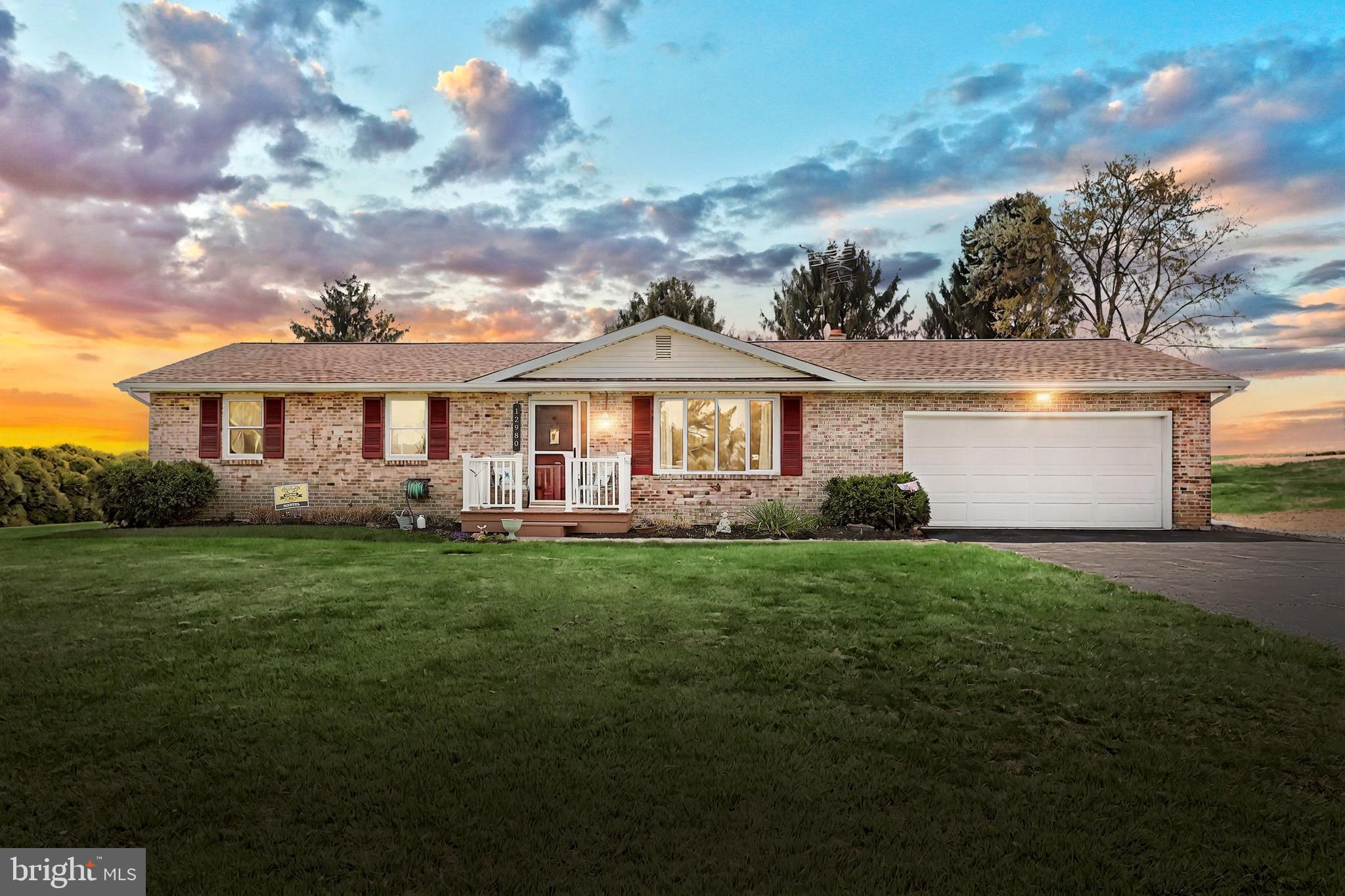 Charming Brick Rancher in a Peaceful Country Setting!
Welcome to your private retreat in the heart of the countryside! This solid brick rancher offers the perfect blend of comfort, style, and serenity, all nestled among lush farmland in the Red Lion School District.
Inside you'll find a meticulously maintained one-owner home with 3 spacious bedrooms and 2 full bathrooms, including a lovely primary suite featuring a walk-in tiled shower. The beautifully designed kitchen boasts granite countertops, a stylish tile backsplash, custom-made kitchen island,  and plenty of room to cook and gather.
Downstairs you'll find a cozy family room with a wood stove, perfect for those chilly nights.  On the other side of the basement there is ample storage space and room for a workshop or workout area.  Currently the third bedroom is being used as a laundry room for the convenience of One-Floor Living . If desired, you may convert it back into a bedroom, as there is another laundry hookup in the basement.  
Step outside and enjoy the peaceful backyard oasis, complete with a massive 25' x 24' deck and extended patio – ideal for entertaining, hosting a BBQ or simply soaking in the privacy. The oversized 2-car garage and ample parking provide plenty of space for vehicles, hobbies, or guests. Don't let the country setting fool you, you're only 15 mins to the high school and less than 30 mins to major shopping, the MD line and Lancaster Co. You won't want to miss your chance to see this home, schedule a showing today! Home Sale includes additional parcel. Combined Acreage is 0.715.