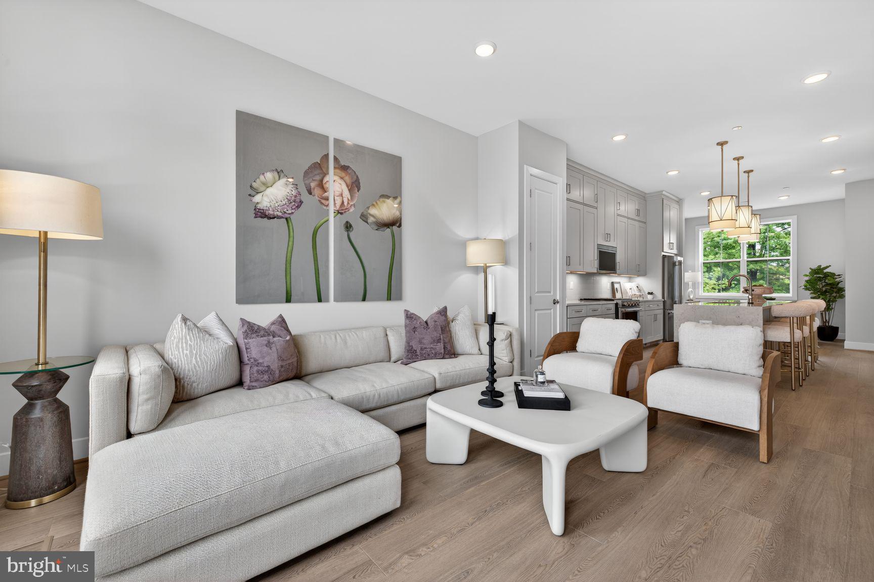 New Construction at Northpark Towns by Tri Pointe Homes. Our award winning, beautifully designed 4-story townhome blends modern comfort, sophisticated style, and unbeatable convenience just minutes from Pike & Rose, less than a half mile to North Bethesda Metro, dining, shopping, and major commuter routes.  Step inside the bright and welcoming main level featuring a spacious great room that opens to the outdoor living, dining area, and a center kitchen. Designed with both function and style in mind, the kitchen showcases Blanc Elysee Polished quartz countertops, Brellin PureStyle White cabinets, KitchenAid stainless steel appliances, and gold hardware. The bedroom level offers a primary suite with walk-in closets and private bath, plus an additional bedroom with its own full bath. The loft level offers even more flexibility with an additional bedroom and full bath. The lower level is complete with a rec room and additional powder room. Photos shown are of a similar home.