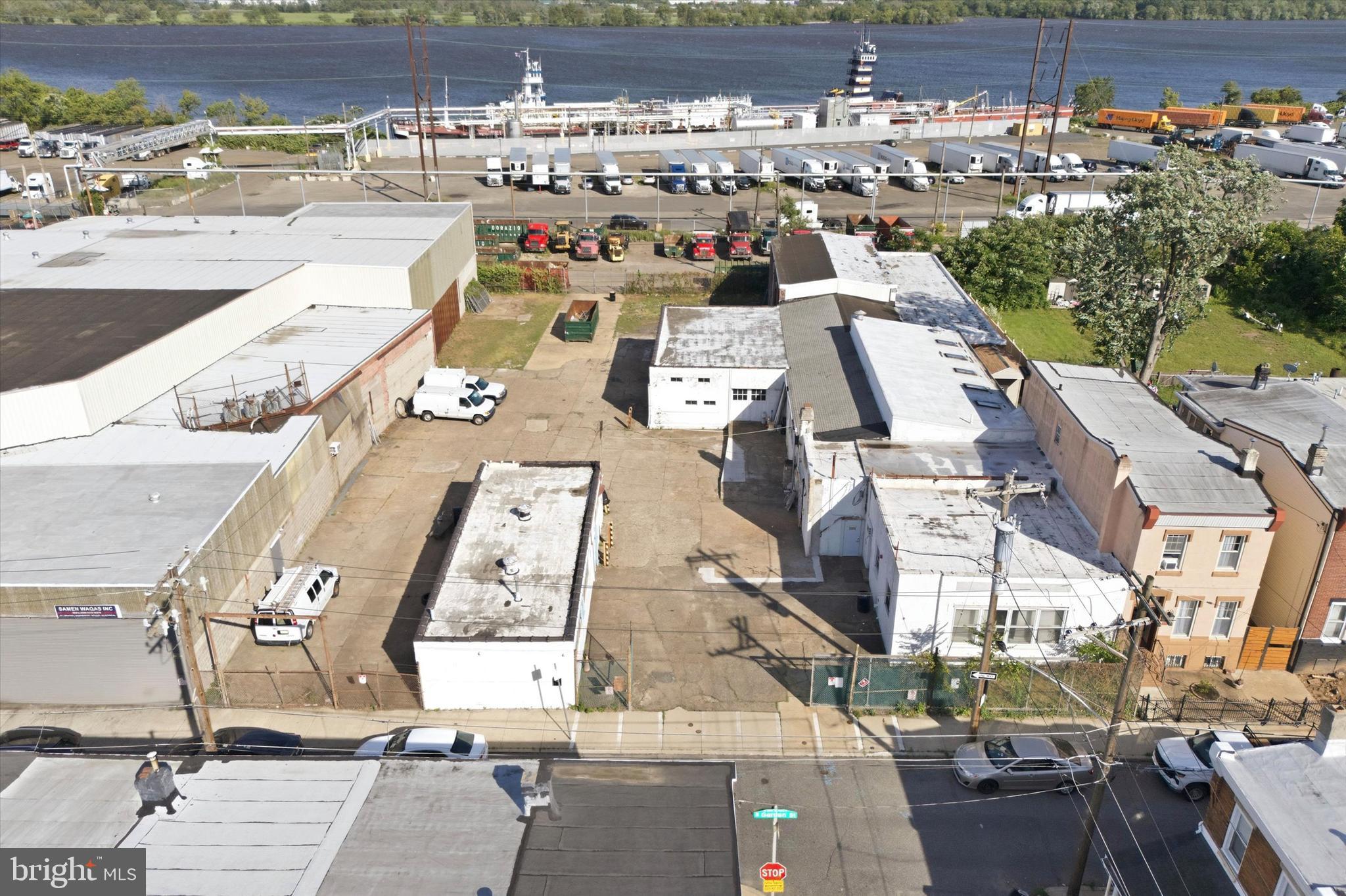 Positioned in Philadelphia's established Bridesburg industrial corridor, 4821 Garden Street presents a rare opportunity to acquire a substantial commercial property with exceptional flexibility, scale, and future potential. Spanning more than 29,000 square feet of land, this unique site combines expansive outdoor space, multiple structures, and a strategic location near major transportation routes, making it an attractive offering for owner-users, investors, and developers alike. The property is anchored by a 9,000+ square foot industrial building featuring soaring ceilings, open warehouse space, and a versatile layout well-suited for manufacturing, distribution, storage, fabrication, contractor operations, or adaptive reuse. Rich with character and industrial history, the building offers the size and infrastructure needed to support a wide range of commercial ventures. A separate secondary building provides additional flexibility and is ideally suited for office, administrative, showroom, creative workspace, or support operations, allowing businesses to maintain a dedicated professional environment separate from warehouse or production activities. One of the property's most compelling features is its expansive paved yard and oversized footprint, providing abundant room for vehicle parking, fleet storage, equipment staging, outdoor storage, or future site improvements. Adding to its appeal, the property enjoys proximity to the Delaware River waterfront and is surrounded by a longstanding network of industrial and commercial businesses. Whether your vision involves continuing its industrial use, expanding operations, repositioning the asset, or exploring redevelopment opportunities, 4821 Garden Street offers the scale, location, and versatility to bring that vision to life.