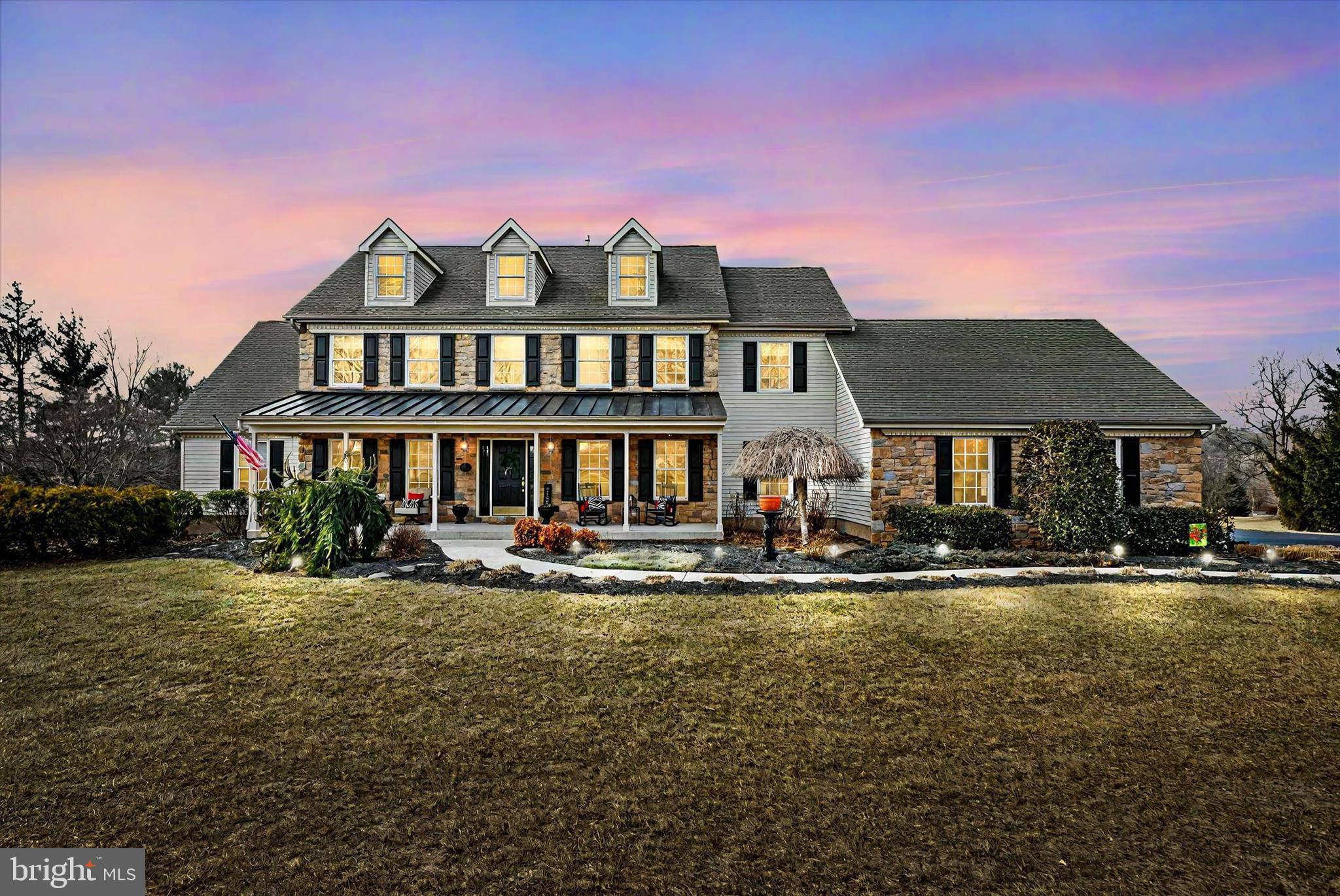 Welcome to The Estates at Brookside and 4020 Fountain Circle, a distinguished residence in this exquisite enclave of 33 homes nestled in bucolic Fountainville, PA, just minutes from Doylestown. Originally  the builder’s own home, this stunning property seamlessly blends understated elegance with modern comfort, offering a truly exceptional living experience.
As you approach, lush, meticulous landscaping sets the tone for the warmth and character that define this home. The expansive farmhouse-style front porch invites you to sit back on a rocker or sway on the porch swing while taking in the serene surroundings.
Step through the gracious foyer, where a living room (currently an office) sits to the left, and on the right, a spacious dining room with elegant case wainscoting and crown molding. Make your way through the foyer to the light-filled, two-story family room, where a fireplace with stone surround and shiplap accents creates a cozy retreat on chilly evenings. The family room flows seamlessly to the heart of the home, the country kitchen with breakfast area and center island. The kitchen features newer stainless-steel appliances, quartz countertops (2021), tile backsplash and abundant cabinet space. The first-floor laundry/mudroom with granite countertop (2021) provides access to the 3-car attached garage.
Down the center hallway to the other side of the home, you’ll find a recently refreshed powder room and the gracious 1stfloor primary suite. Tucked in its own wing, the primary suite is a secluded retreat with a huge ensuite bathroom with dual granite-topped vanity, two linen closets, a generous walk-in closet and direct access to the deck and hot tub. 
Upstairs, an open walkway overlooks the family room, enhancing the home’s open, airy feel. There are three large bedrooms and a full bath. One bedroom has a very large walk-in closet, which leads to a full staircase to the massive attic. A door from the center bedroom provides access to additional storage space over the garage. 
The kitchen may be the heart of this home, but if you’re looking for additional recreation or entertainment space, you’ll find it in the fabulous finished basement. Designed for both relaxation and recreation, the basement is a standout feature, offering a second full kitchen and a full bath. Game tables (pool, foosball and shuffleboard) and electronic slot machines are included with the sale. An unfinished area currently serves as a workout space, but could also provide additional storage or a workshop area. With direct egress to the yard, the basement could potentially become an in-law or au-pair living area.
Outdoor living space? You’ll find it here! Set on over 3 acres, this property provides plenty of room to roam or relax. The composite deck spans nearly the length of the home and affords sweeping vistas; a motorized awning provides shade and two exterior closets supply extra storage. Imagine relaxing evenings in the hot tub under the stars. Or gather around the built-in fire pit – perfect for crisp nights with friends and family.
A staircase at the rear of the property leads to a wooden bridge over a babbling brook and a truly unique feature: a detached 4-bay garage with its own driveway–a dream for car enthusiasts, collectors, or hobbyists. Measuring approx. 30’ X 60’, this garage offers heavy power and workshop space. For fun, there’s even a pickleball court with a portable net!
A 2-zone heating and cooling system with 3 air handlers ensures comfort throughout the house. There are a 75-gallon propane water heater, a water softener, 2 sump pumps and an on-demand generator.
This home offers exceptional craftsmanship and pride of ownership with thoughtful updates including brand-new (2025) flooring throughout the first floor and updated lighting and faucets. A neutral color palette offers the perfect backdrop for your personal touches. This home is a must-see for the discerning buyer - schedule your private tour today!