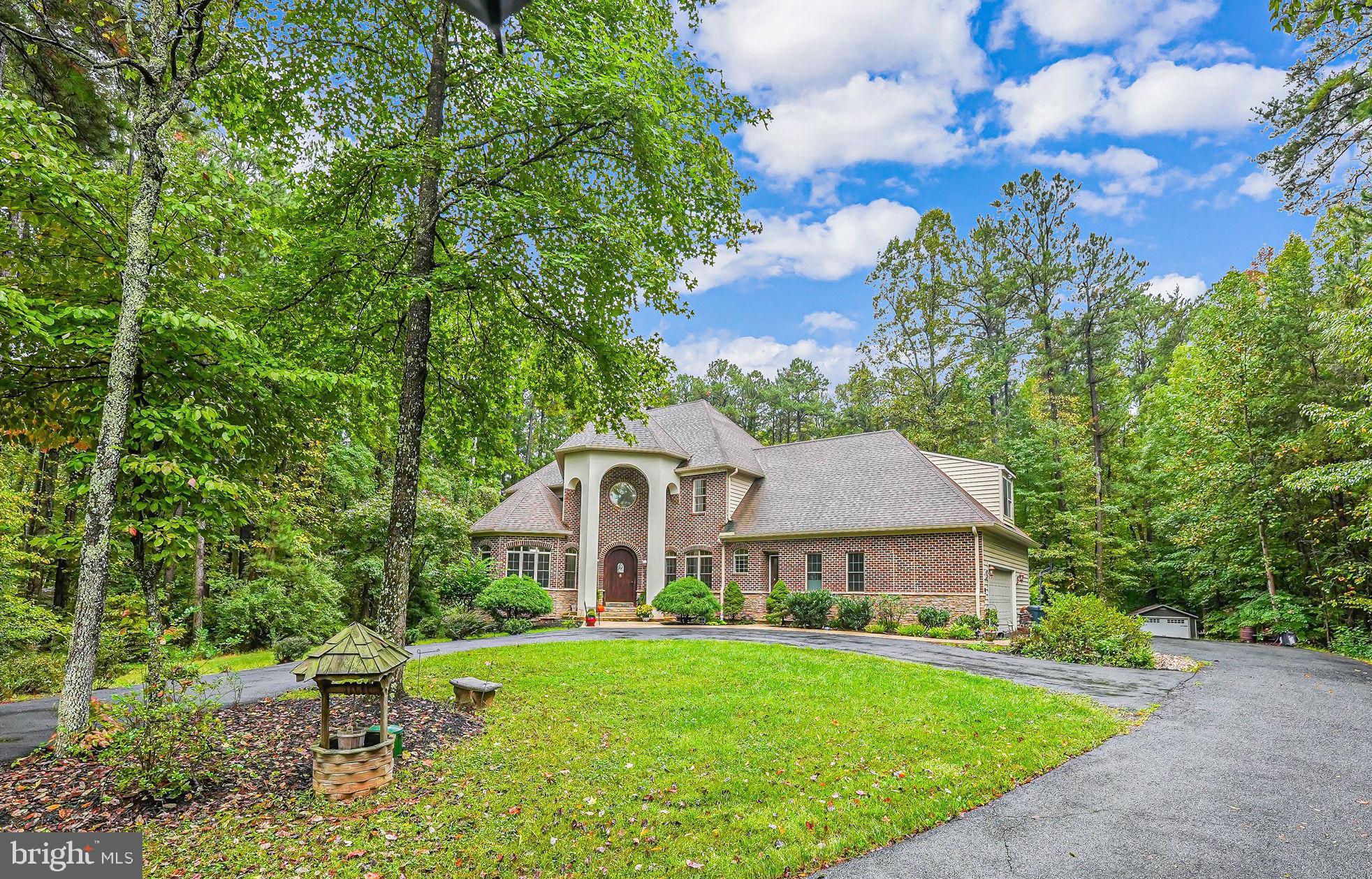 Welcome to this unique offering. Wonderful curb appeal with circular driveway leads to impressive custom home with numerous quality features thru-out. Distintive brick and stone front with 6 BR, 5 1/2 BA . MAIN LEVEL PRIMARY  BR  sits on over 4 ac lot in sought after Seven Lakes community.  Over 6700 sq ft on 3 levels. Elegant and dramatic public spaces and exceptional lower level layout. Upper level has large BR2 with ensuite bath and 2 BRs with jack & jill bath. All bedrooms have walk in closets.. Long list of features.... including 3 zone HVAC (2 gas &1 HP)  Two water heaters (one gas & one electric).Oversized garage with storage space. Main lev laundry/mud room with dog wash area . Plus a stack unit washer/dryer in lower lev.  Wonderful kitchen with French feeling has to be seen.Theater room with built in seats  and wet bar with fridge; BR5 has murphy bed and ensuite bath,  BR6 is huge and part of separate area with family rm/kitchen with outside entrance.h more...  Private and serene lot with level back yard and covered patio with hot tub.OWNERS HAVE FOUND HOME OF CHOICE...