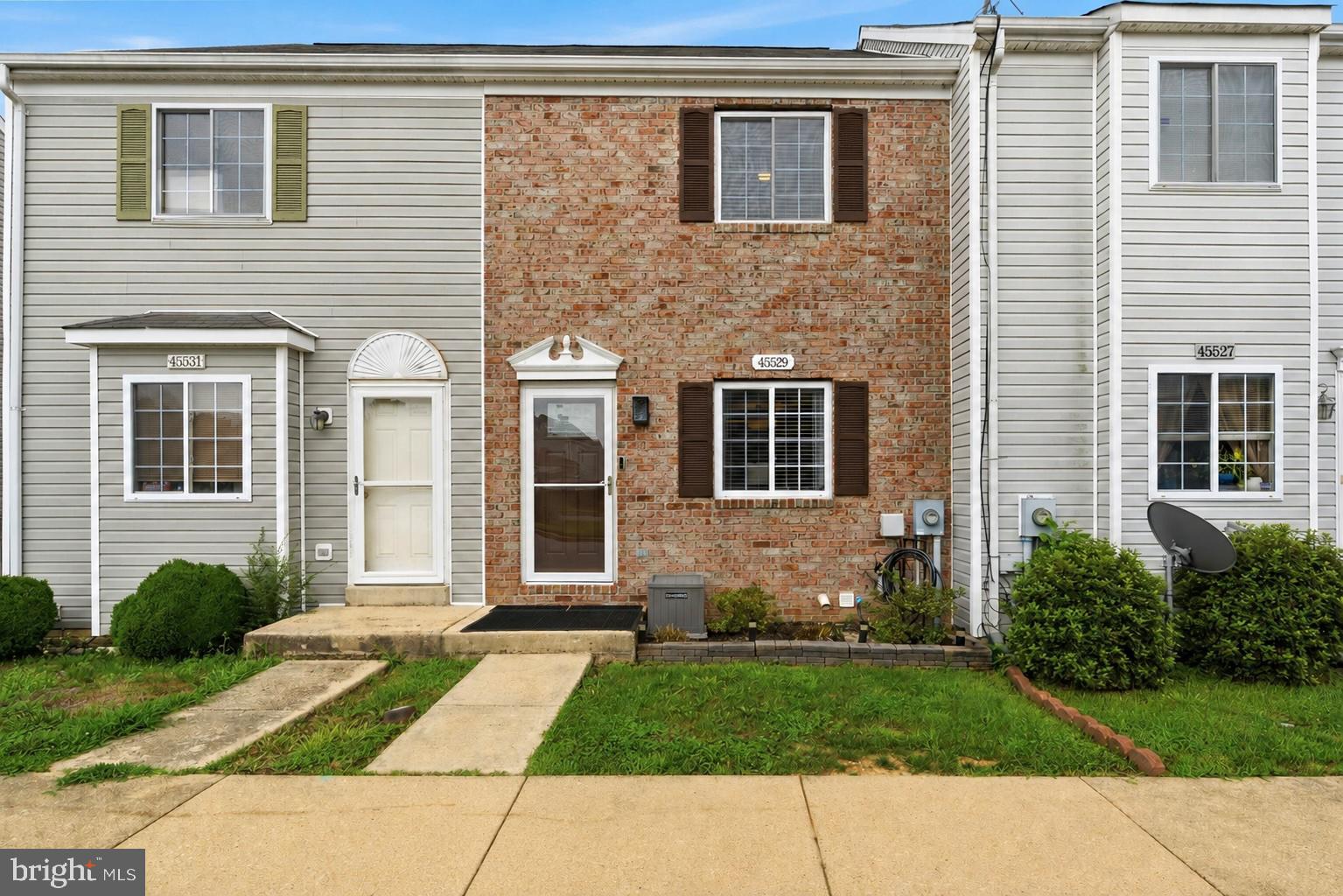 MOVE-IN READY WITH DUAL EN-SUITE BEDROOMS!! Welcome home to this beautifully maintained 2/3-bedroom, 2.5-bath townhouse in the heart of Great Mills, offering stylish updates, spacious living, and a private wooded backdrop. With three finished levels, two en-suite bedrooms, and numerous recent improvements, this home is the perfect blend of comfort, convenience, and value.

Step inside to a bright, open-concept main level featuring new luxury flooring (2025) throughout the living and dining areas. The spacious living room flows seamlessly into the updated kitchen, complete with white cabinetry, stainless steel appliances, a breakfast bar, new kitchen faucet (2025), and new garbage disposal (2026). The dining area opens directly to the rear deck, creating the perfect space for indoor-outdoor entertaining while overlooking peaceful woods. A new dining room light fixture (2026) adds a fresh, modern touch.

Upstairs, you'll find two generously sized bedrooms, each featuring its own private en-suite bathroom, providing exceptional comfort and privacy for family members, guests, or roommates. New blinds throughout the home (2024) and a new ceiling fan in one of the bedroom suites (2025) complete the upper level.

The fully finished walkout lower level offers outstanding flexibility with a spacious recreation room centered around a cozy gas fireplace. Whether you envision a second family room, home gym, office, media room,3rd bedroom or playroom, this versatile space adapts to your lifestyle. Step outside to the fenced backyard and patio, providing additional outdoor living space with room to relax, entertain, or let pets play.

Recent improvements offer peace of mind, including a new furnace (2021), heat pump (2021), hot water heater (2021), HVAC condensate pump (2025), and new deck boards installed in 2024, making this home truly move-in ready.

Conveniently located just minutes from NAS Patuxent River, shopping, restaurants, parks, and schools, this home offers an ideal location for commuters and anyone looking to enjoy everything Southern Maryland has to offer.

Don't miss this opportunity to own a beautifully updated townhouse featuring the highly desirable dual en-suite layout, finished walkout lower level, gas fireplace, and peaceful wooded setting in the heart of Great Mills!
