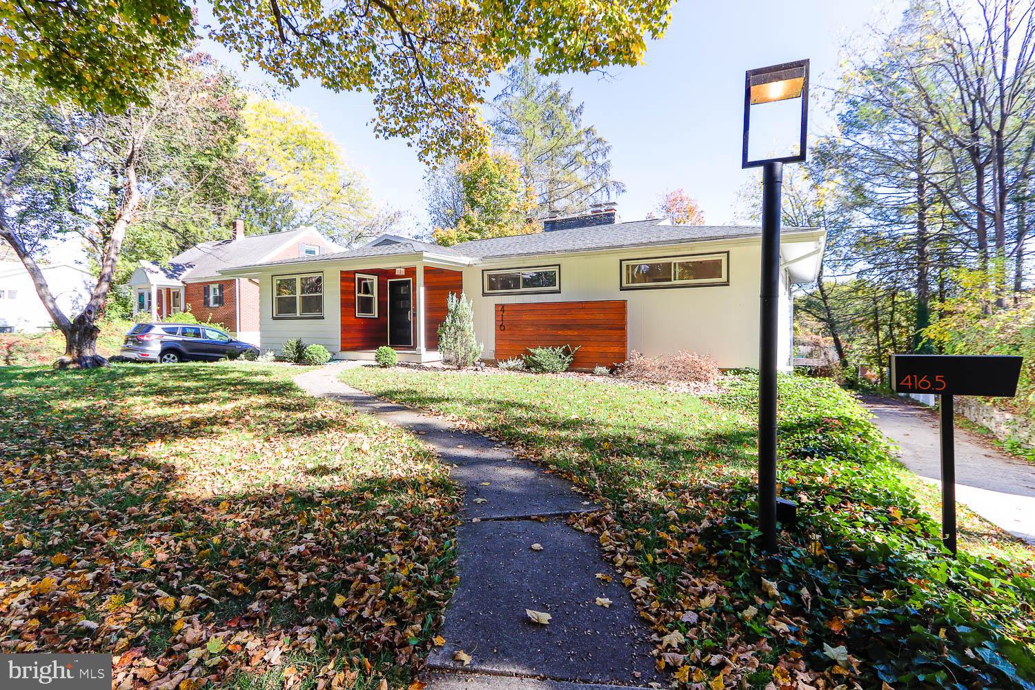 Iconic, historic charm of mature tree lined Irvin Ave within the Highlands neighborhood of the State College Borough, 416 E Irvin encapsulates mid-century charm and modern amenities.  Built in 1956, this single-story ranch features - hardwood floors, a first-floor primary bedroom, a spacious eat-in kitchen and a permitted one-bedroom apartment with income potential.  Celebrating the hallmark of mid-century modern design, floor to ceiling windows in the main living room and dining room invite the outside in, a sandstone trimmed fireplace, built in shelves and newer bespoke light fixtures give a nod to this time period. 

A sprawling kitchen with abundant storage is framed in shaker style solid oak cabinetry with tile backsplash and floors.  Professionally renovated bathrooms (2019) are a spa-like retreat featuring elongated picket tile walls and retro inspired tile floors still maintaining the charm of the original era.  Custom vanity and globe pendant light in the main bathroom create a warm and designed forward space.  Additional living area in the lower-level features large windows, built-ins, closets, another sandstone fireplace and knotty pine paneling embracing the timeless character of this flexible living space.  A fully equipped laundry room with washer and dryer with walkout access to the outside and an additional fully renovated bathroom with tile shower complete the lower level of the main house.  The separately metered lower-level apartment with separate entrance consists of a living room, one-bedroom, full kitchen, bathroom and washer and dryer, currently rented for $850/month, providing a fantastic opportunity for supplemental income or an in-law suite.

Step outside to a tree lined backyard oasis complete with expansive wood deck, ideal for grilling, dining and gathering with friends. The generous lot features plenty of green space, a playlet and a large driveway with ample parking - a rare find this close to campus.  Just blocks from Penn State University, this stylish home (with new roof, gutters and exterior design features, 2019) offers the perfect blend of convenience to campus and residential tranquility.  Whether you’re heading to a game at Beaver Stadium, enjoying the Central PA Festival of the Arts or grabbing a coffee downtown, everything is just minutes from your front door.

Some of these photos are virtually staged.